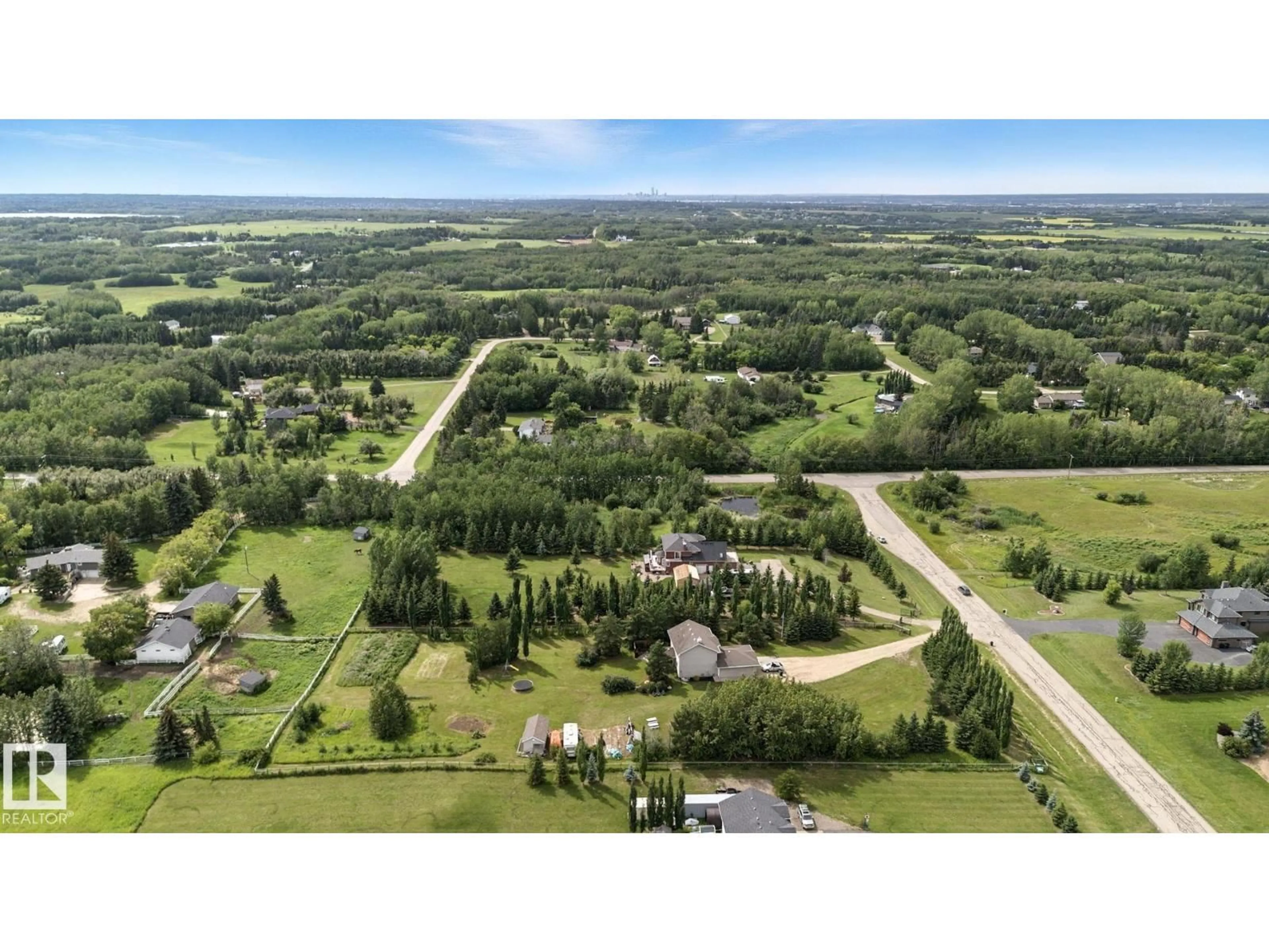 A pic from outside/outdoor area/front of a property/back of a property/a pic from drone, forest/trees view for 13 - 52555 RGE ROAD 223 RGE ROAD, Rural Strathcona County Alberta T8A4P7