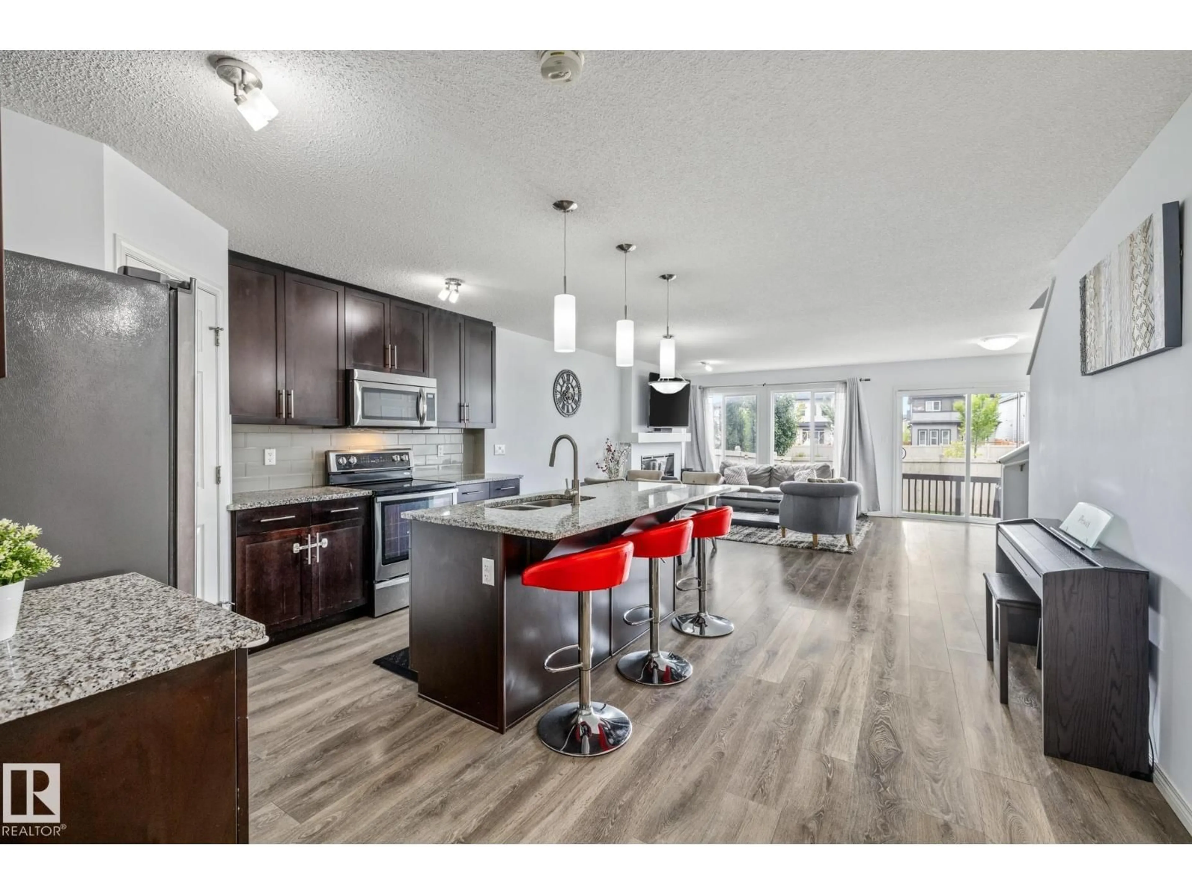 Open concept kitchen, wood/laminate floor for GR SW - 2710 COUGHLAN GREEN, Edmonton Alberta T6W3N8