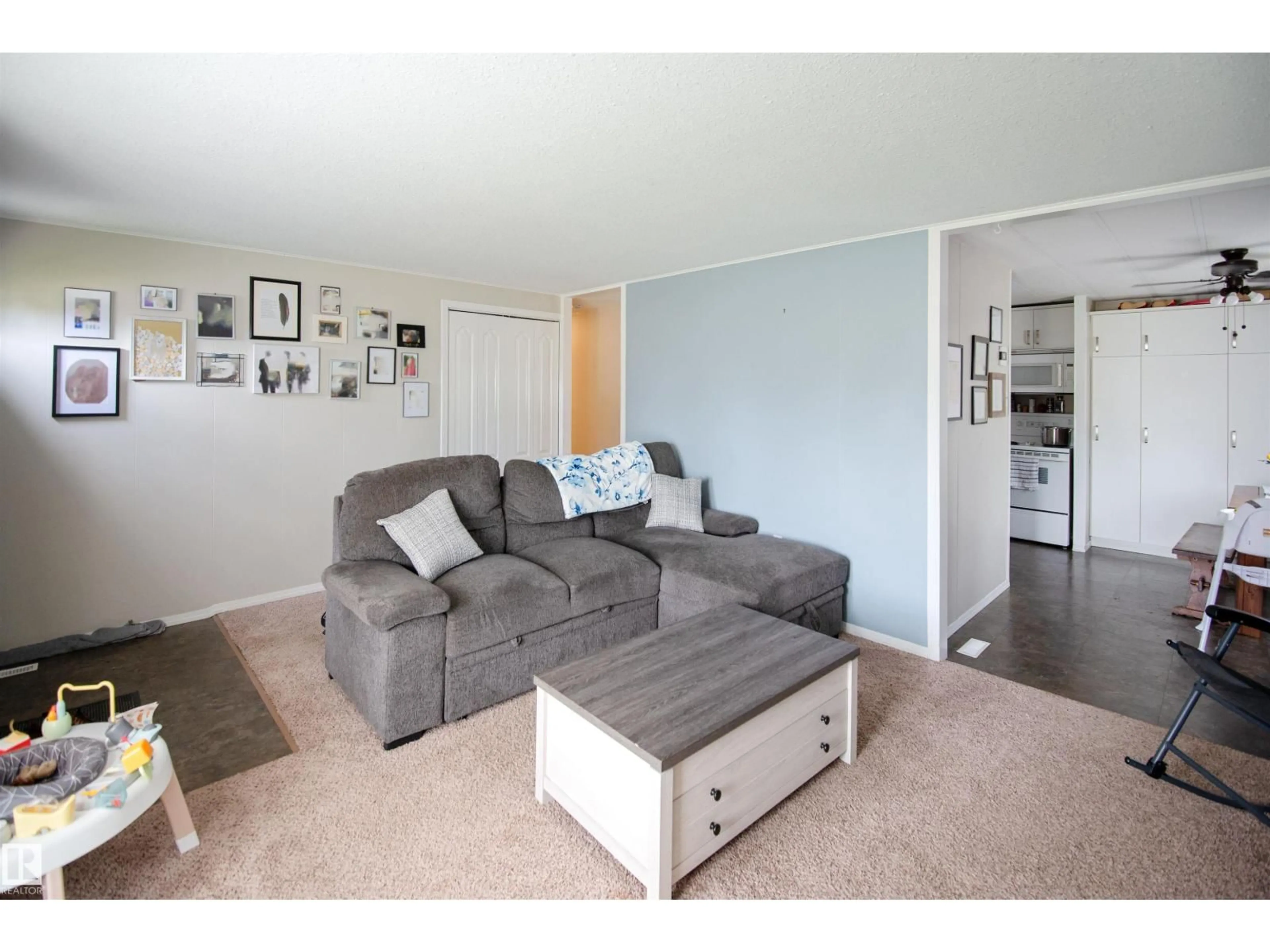 Living room with furniture, wood/laminate floor for 4720 42ND ST, Bonnyville Town Alberta T9N1H9