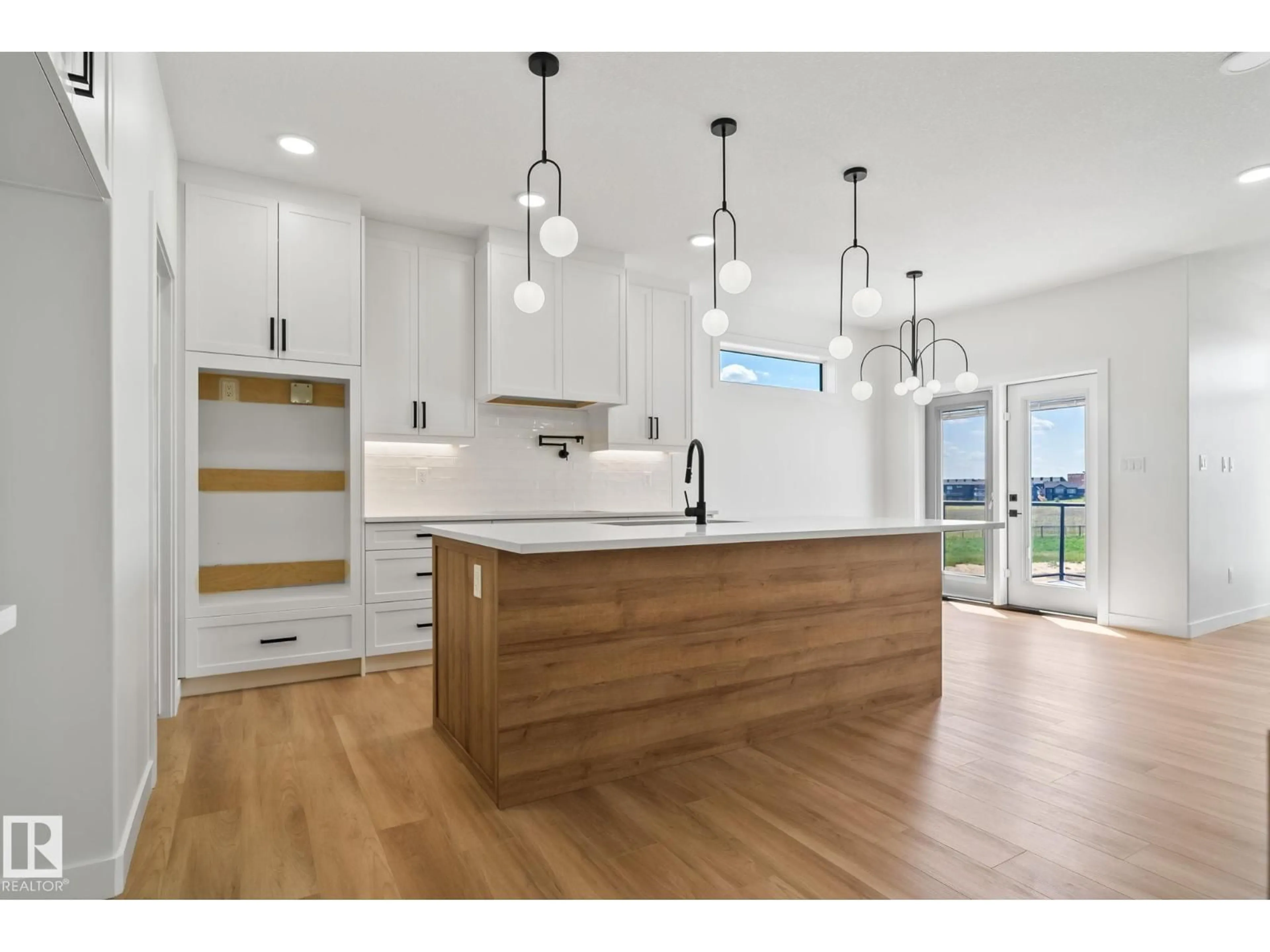 Open concept kitchen, wood/laminate floor for 3138 MAGPIE WY, Edmonton Alberta T5S0E1