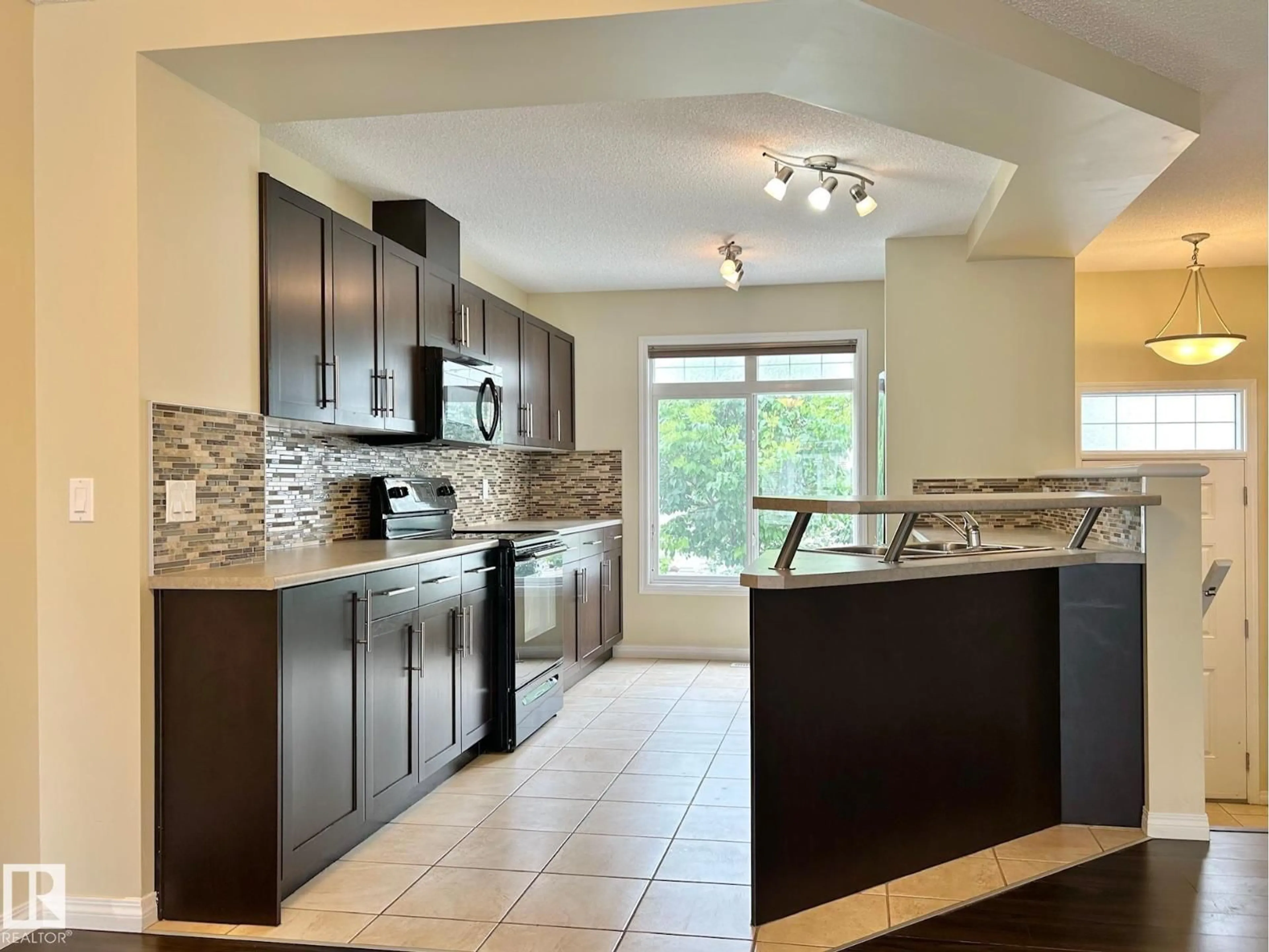 Open concept kitchen, ceramic/tile floor for #143 - 1804 70 ST, Edmonton Alberta T6X0H4