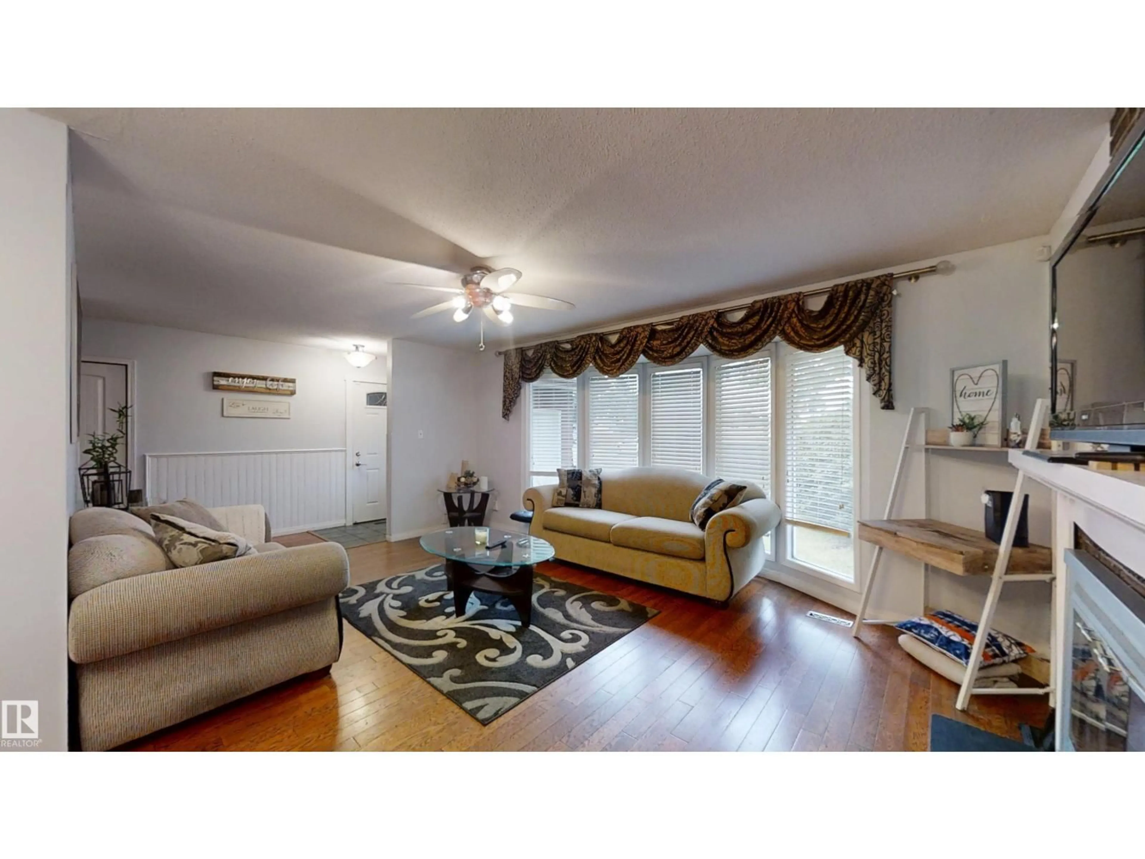 Living room with furniture, wood/laminate floor for 12203 149 AV, Edmonton Alberta T5X2E1