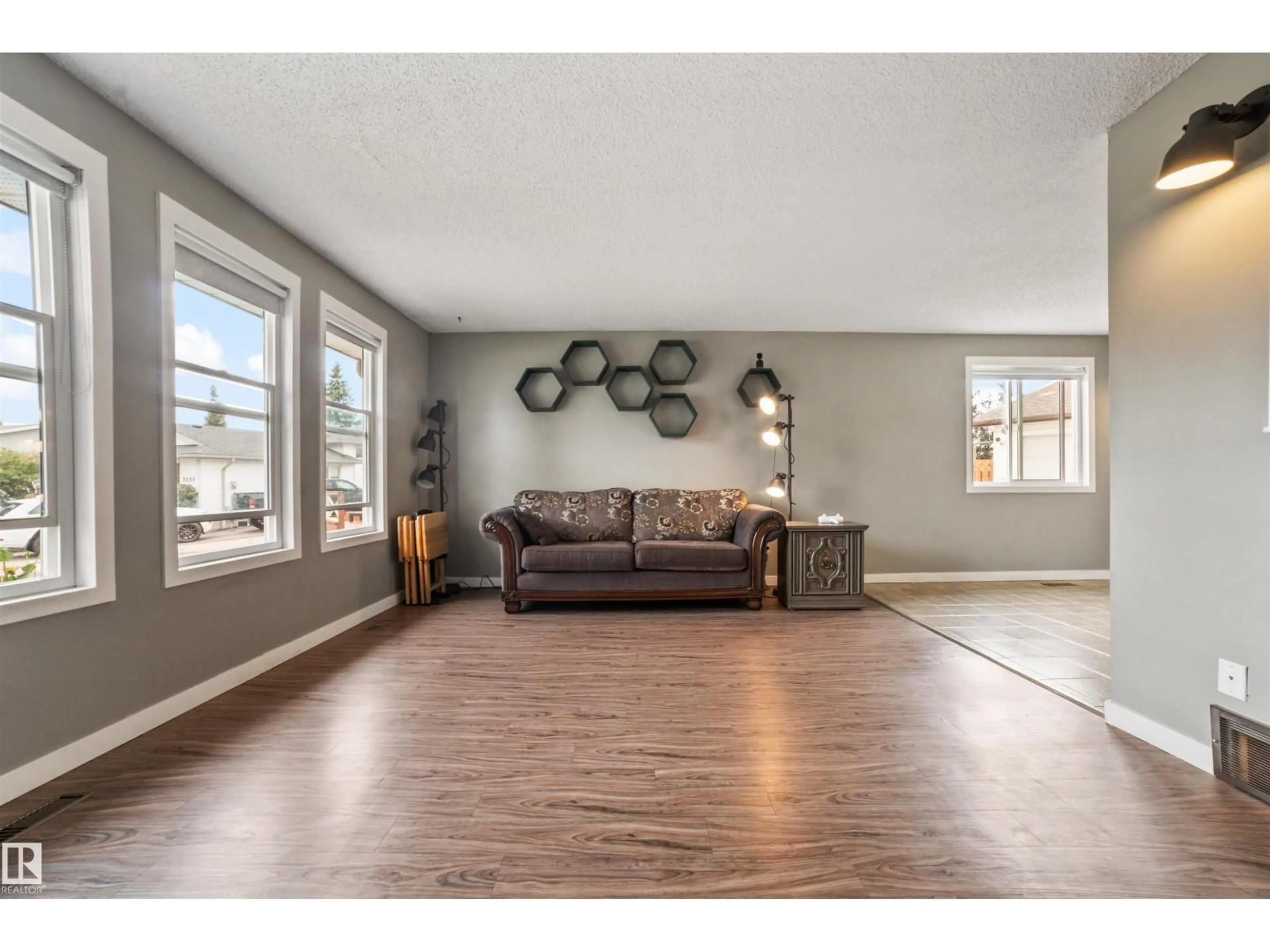 Living room with furniture, wood/laminate floor for 3528 13 AV, Edmonton Alberta T6L3B3