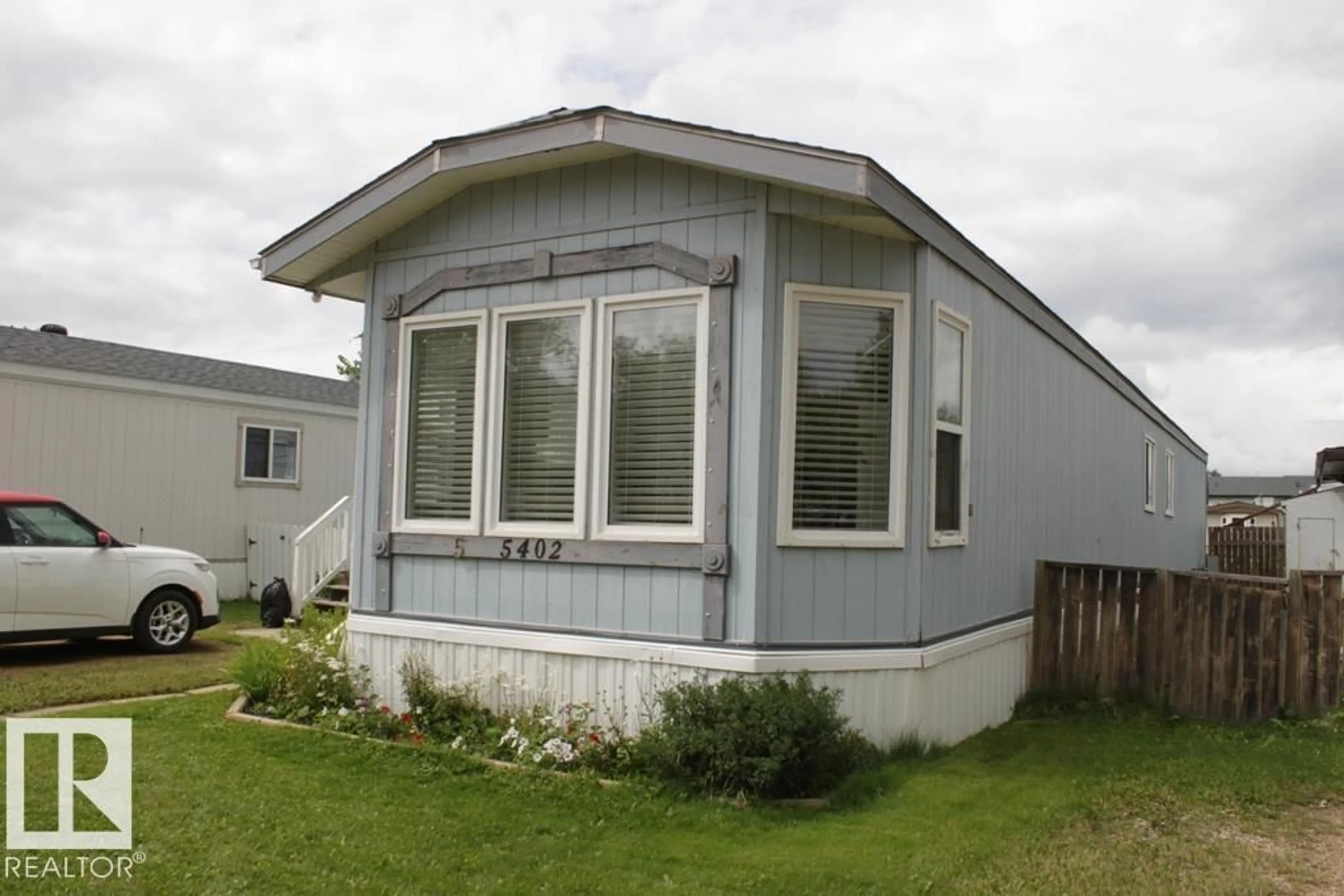 Home with vinyl exterior material, street for 5402 52 ST, Tofield Alberta T0B4J0
