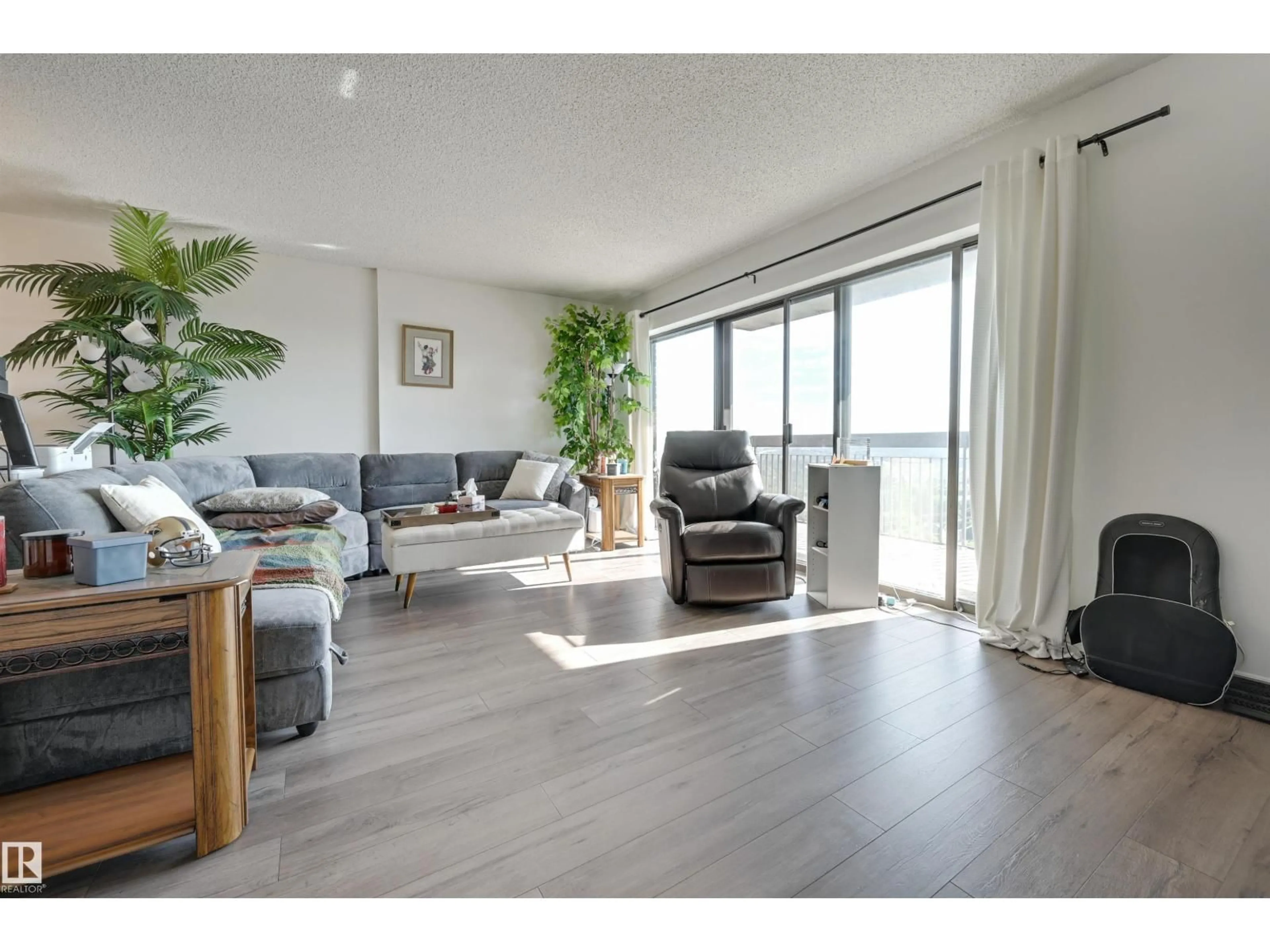 Living room with furniture, wood/laminate floor for 11027 - 1204 87 AV, Edmonton Alberta T6G2P9