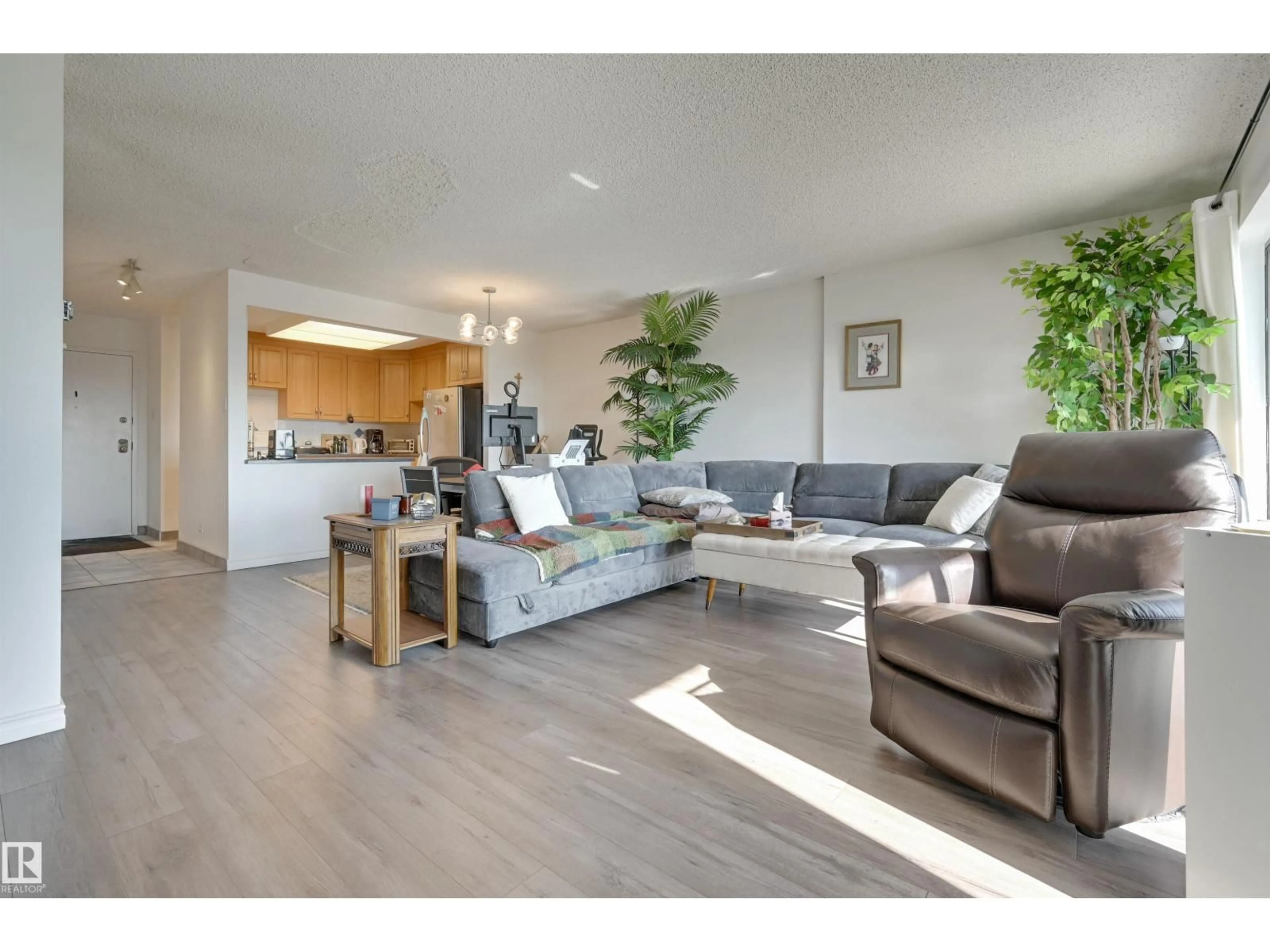 Living room with furniture, wood/laminate floor for 11027 - 1204 87 AV, Edmonton Alberta T6G2P9