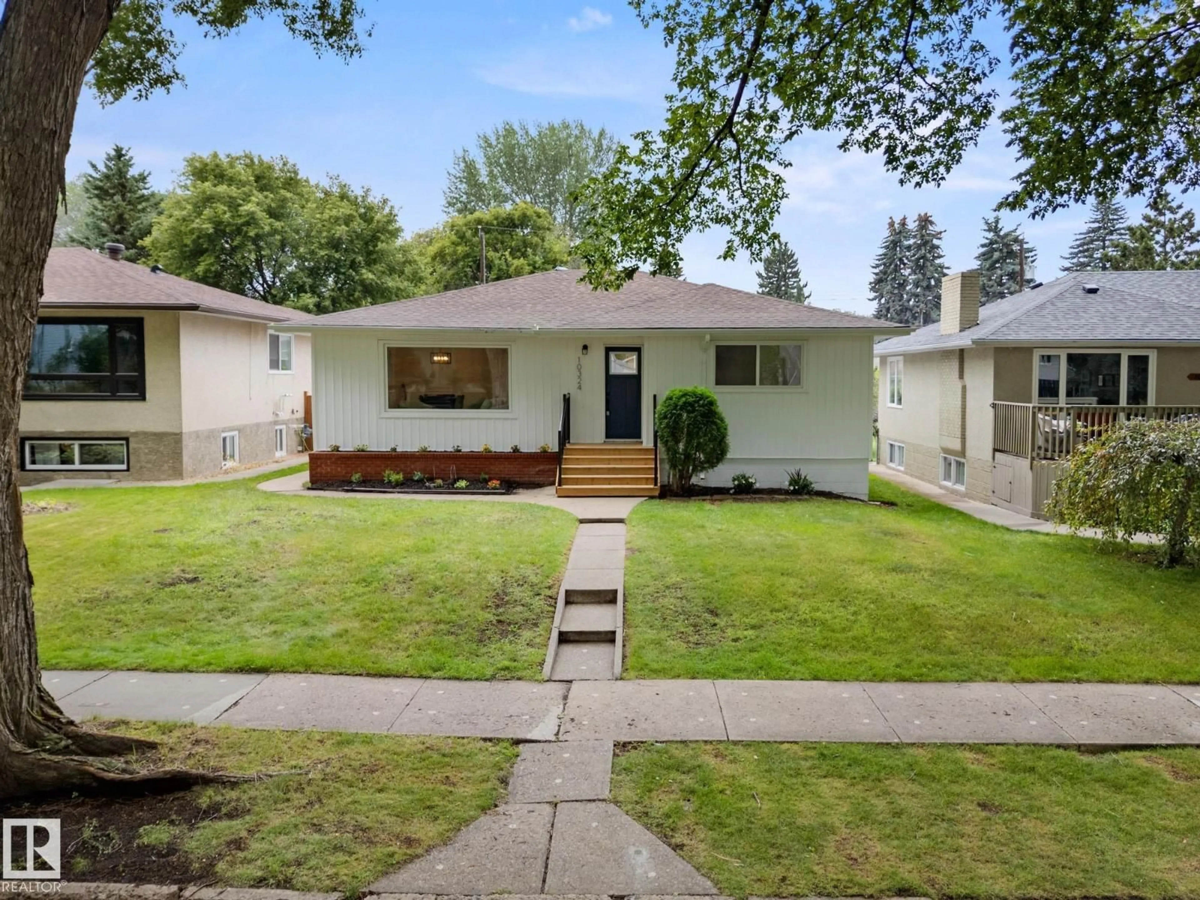 Home with vinyl exterior material, street for NW - 10324 78 ST, Edmonton Alberta T6A3E5