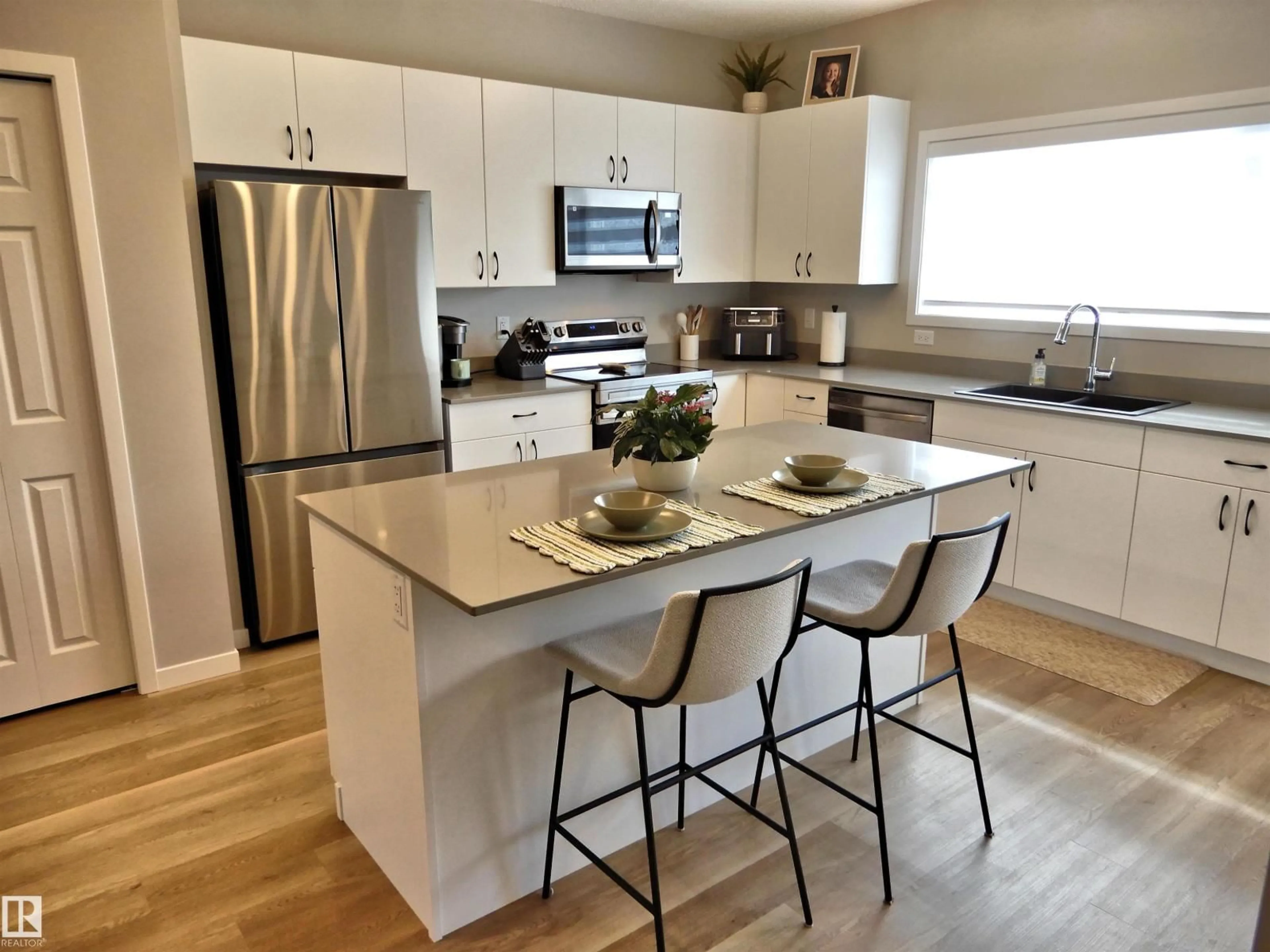 Open concept kitchen, wood/laminate floor for 49 TILIA PL, Spruce Grove Alberta T7X0Z3