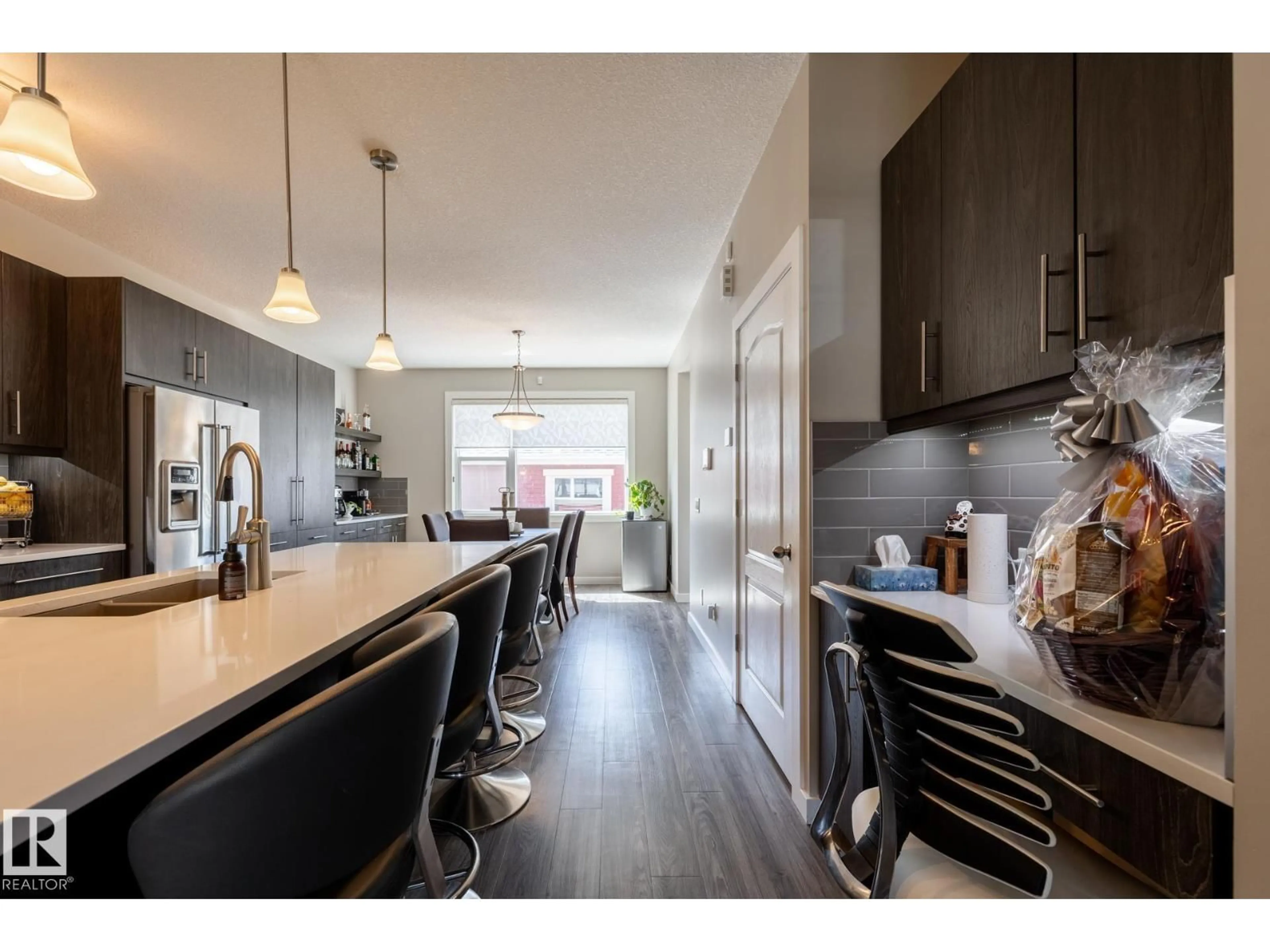 Open concept kitchen, wood/laminate floor for 7403 COLONEL MEWBURN RD, Edmonton Alberta T5E6V7