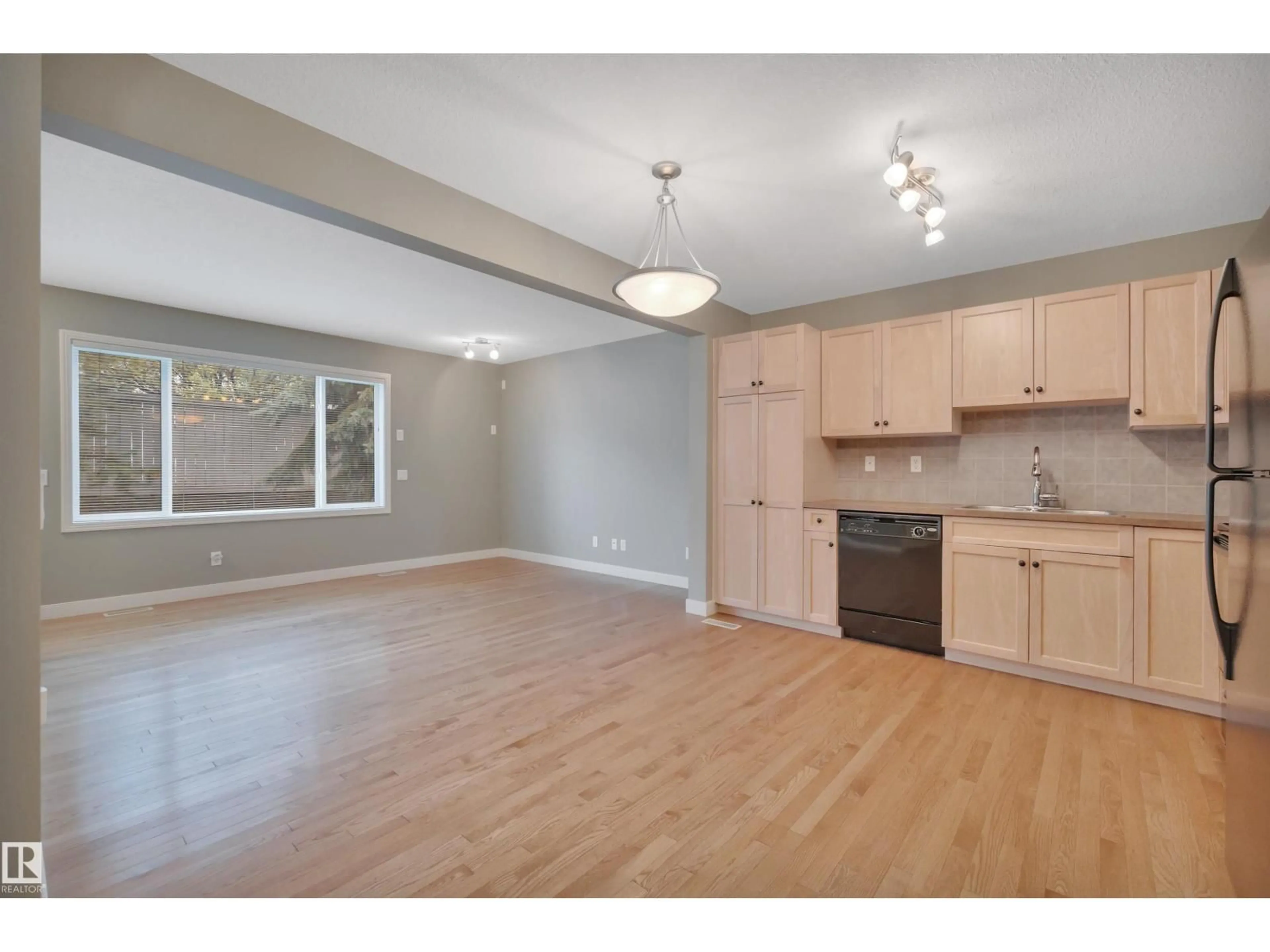 Open concept kitchen, wood/laminate floor for #6 - 2816 34 AV NW, Edmonton Alberta T6T2B4