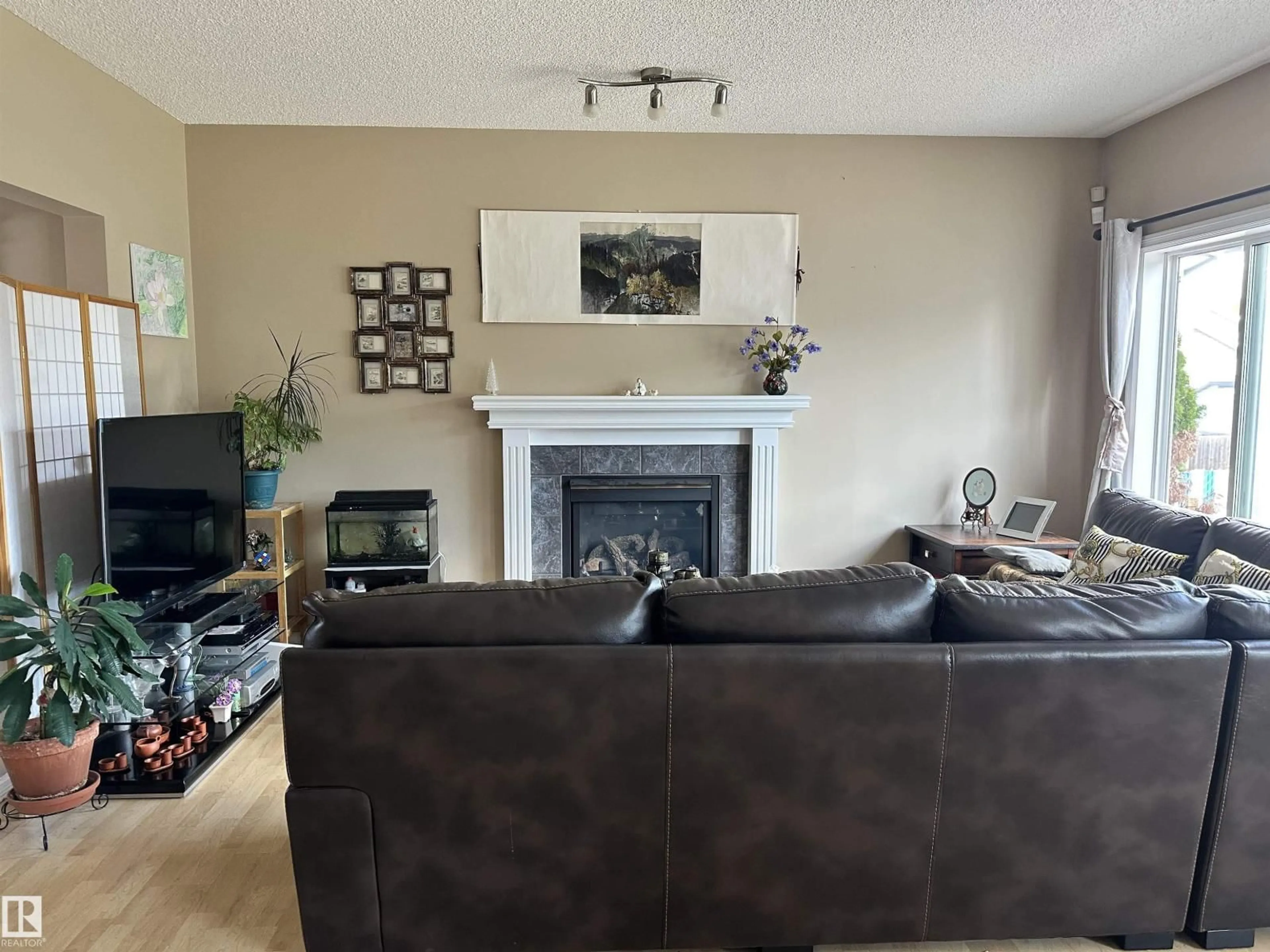 Living room with furniture, wood/laminate floor for NW - 4619 151 AV, Edmonton Alberta T5Y3A1