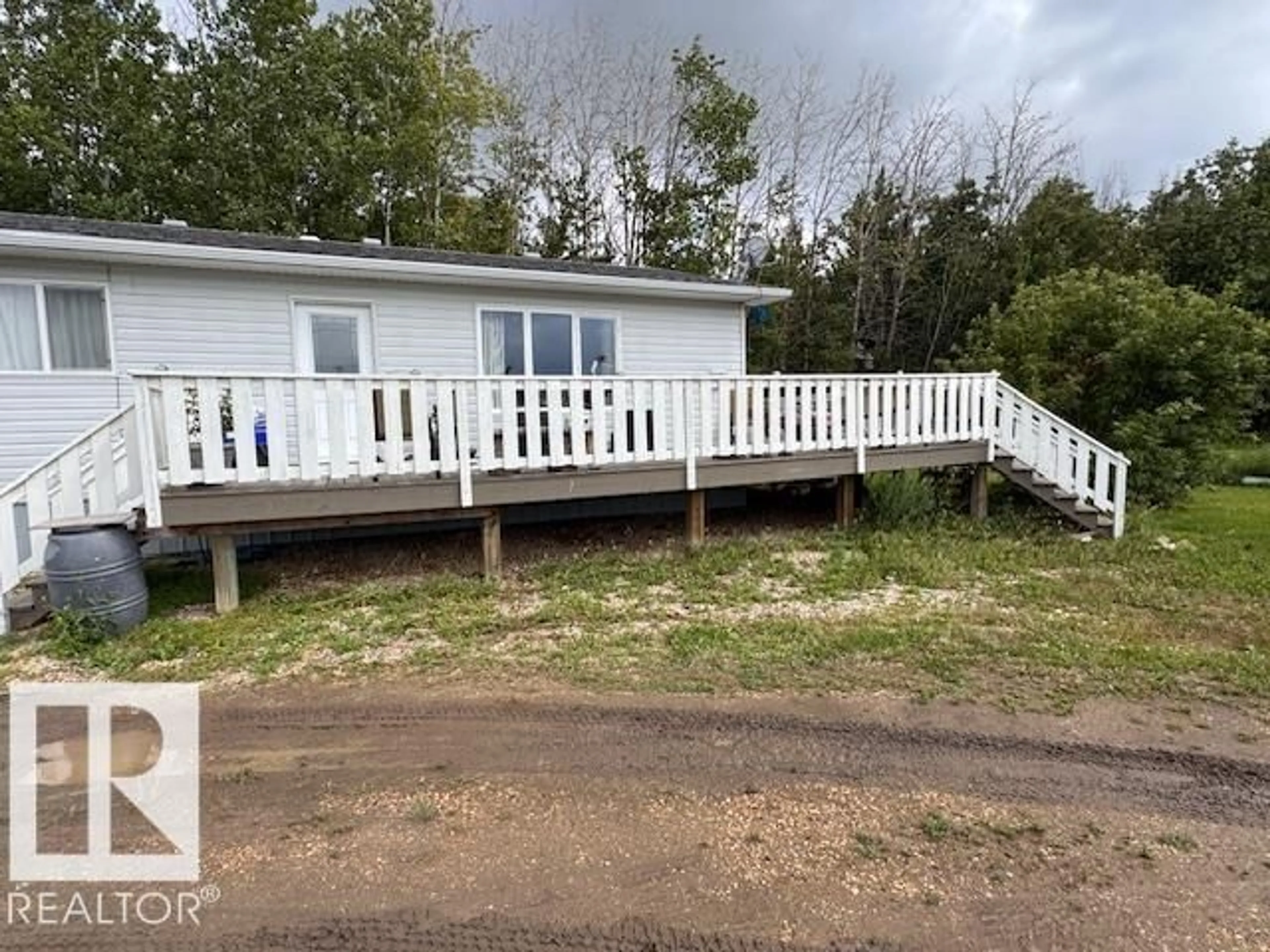 A pic from outside/outdoor area/front of a property/back of a property/a pic from drone, water/lake/river/ocean view for 114 - 5218 HWY 18, Rural Barrhead County Alberta T7N1N3