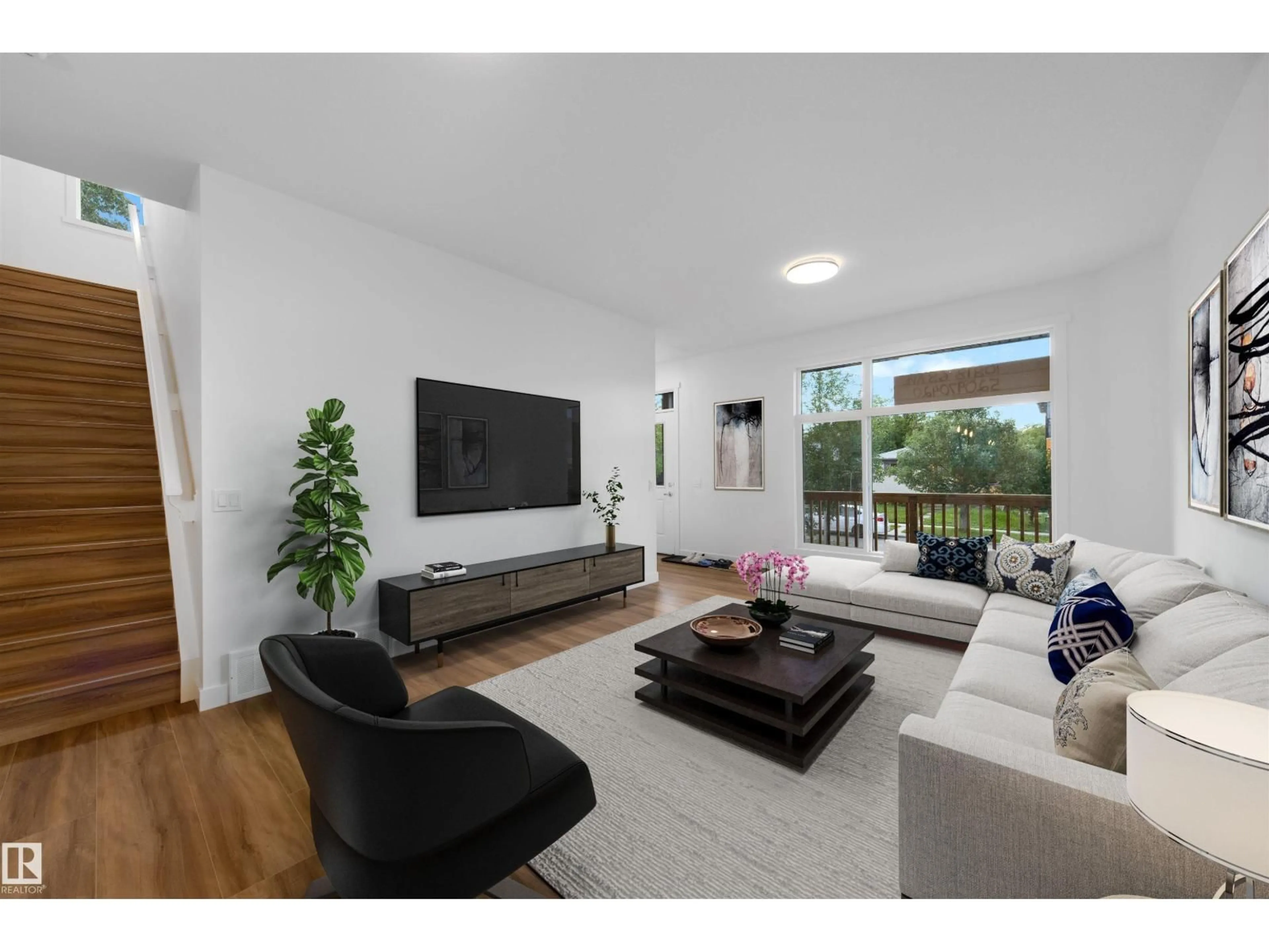 Living room with furniture, wood/laminate floor for 10818 68 AV, Edmonton Alberta T6H2B8