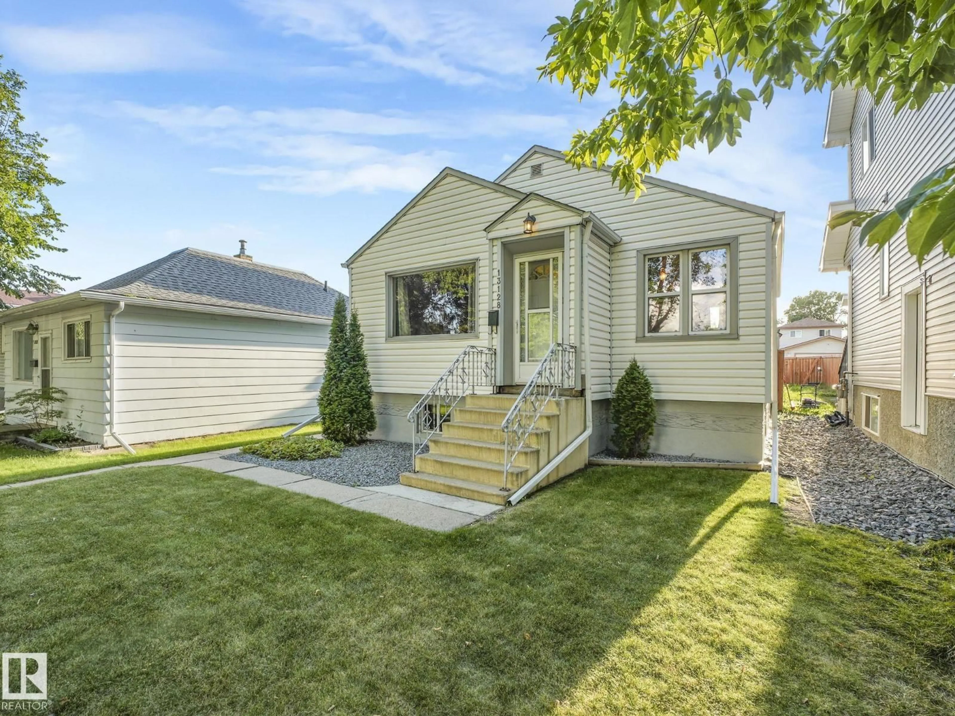 Home with vinyl exterior material, street for 13128 64 ST, Edmonton Alberta T6J6B7