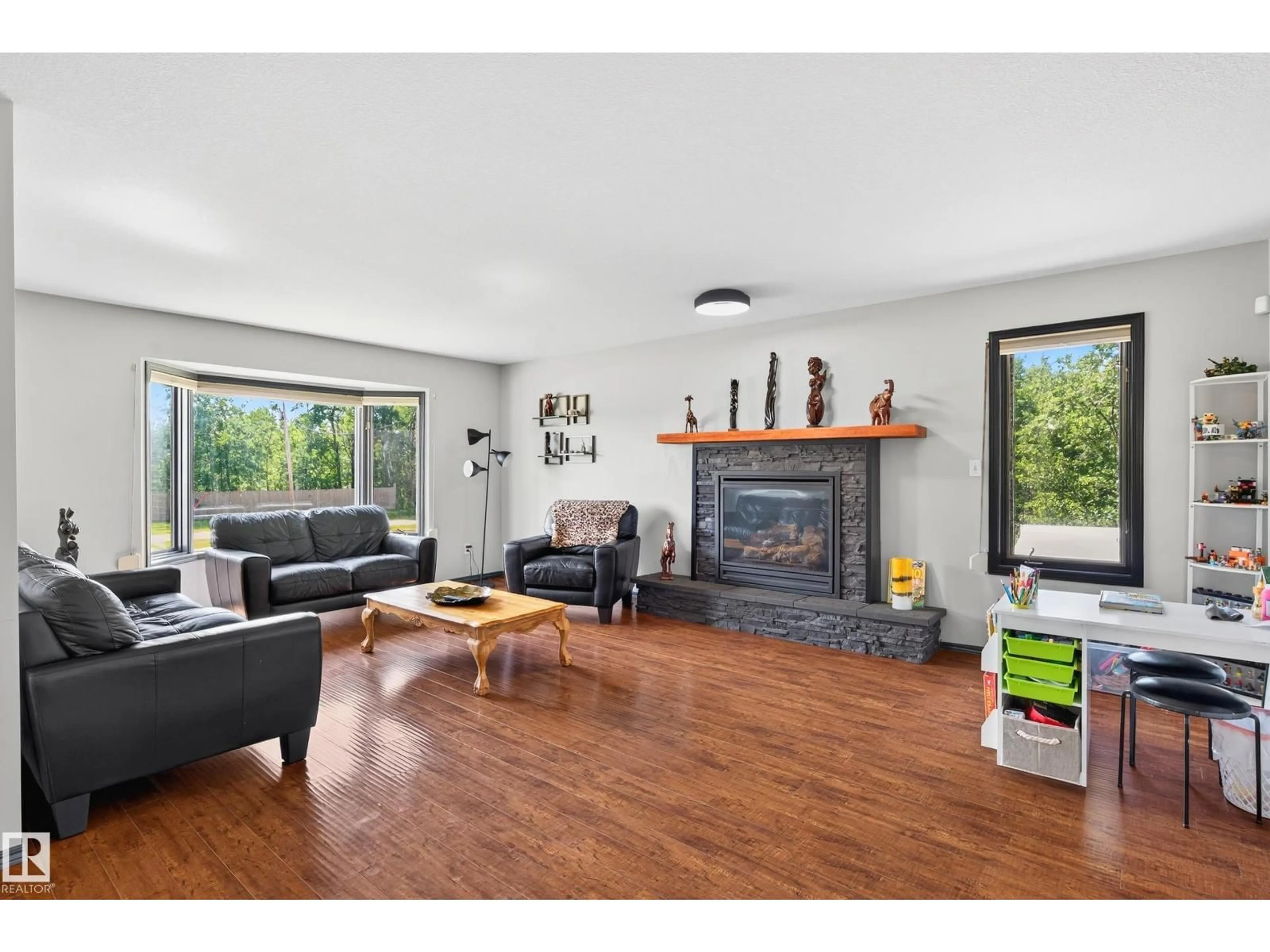 Living room with furniture, wood/laminate floor for 50069 RANGE ROAD 231, Rural Leduc County Alberta T0B3M3