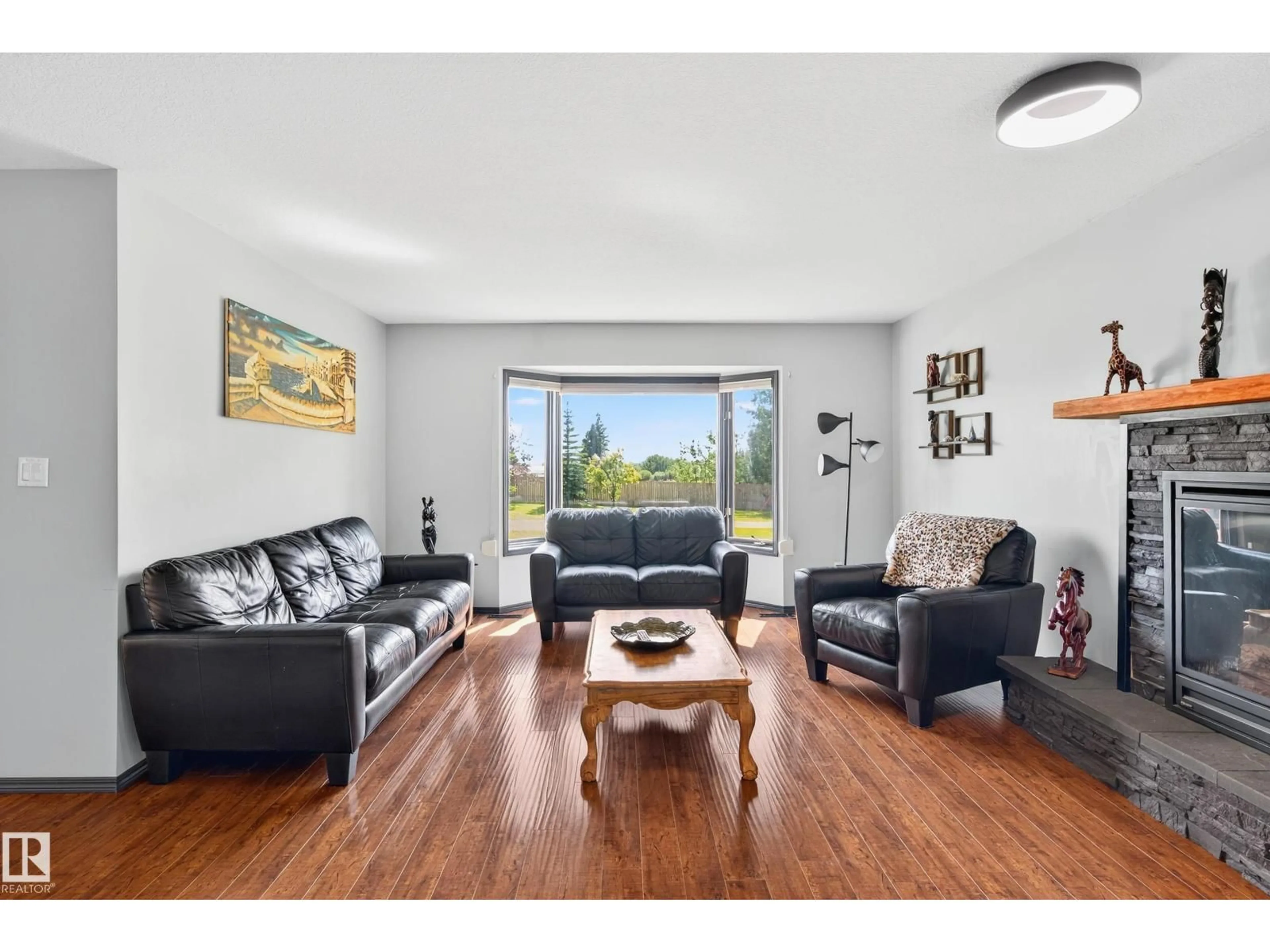 Living room with furniture, wood/laminate floor for 50069 RANGE ROAD 231, Rural Leduc County Alberta T0B3M3