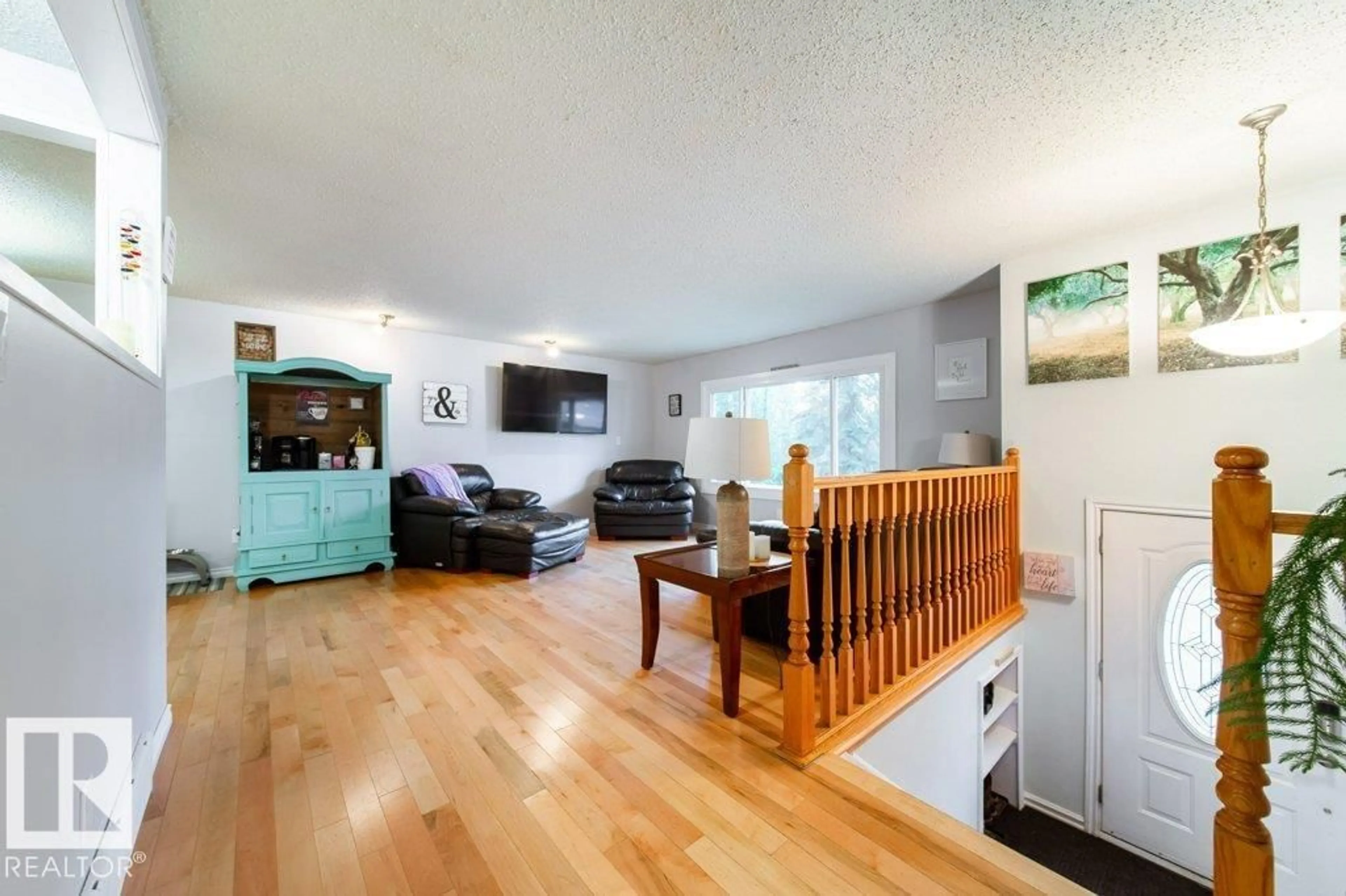 Living room with furniture, wood/laminate floor for 32 2320 TWP ROAD 540, Rural Lac Ste. Anne County Alberta T0E1V0