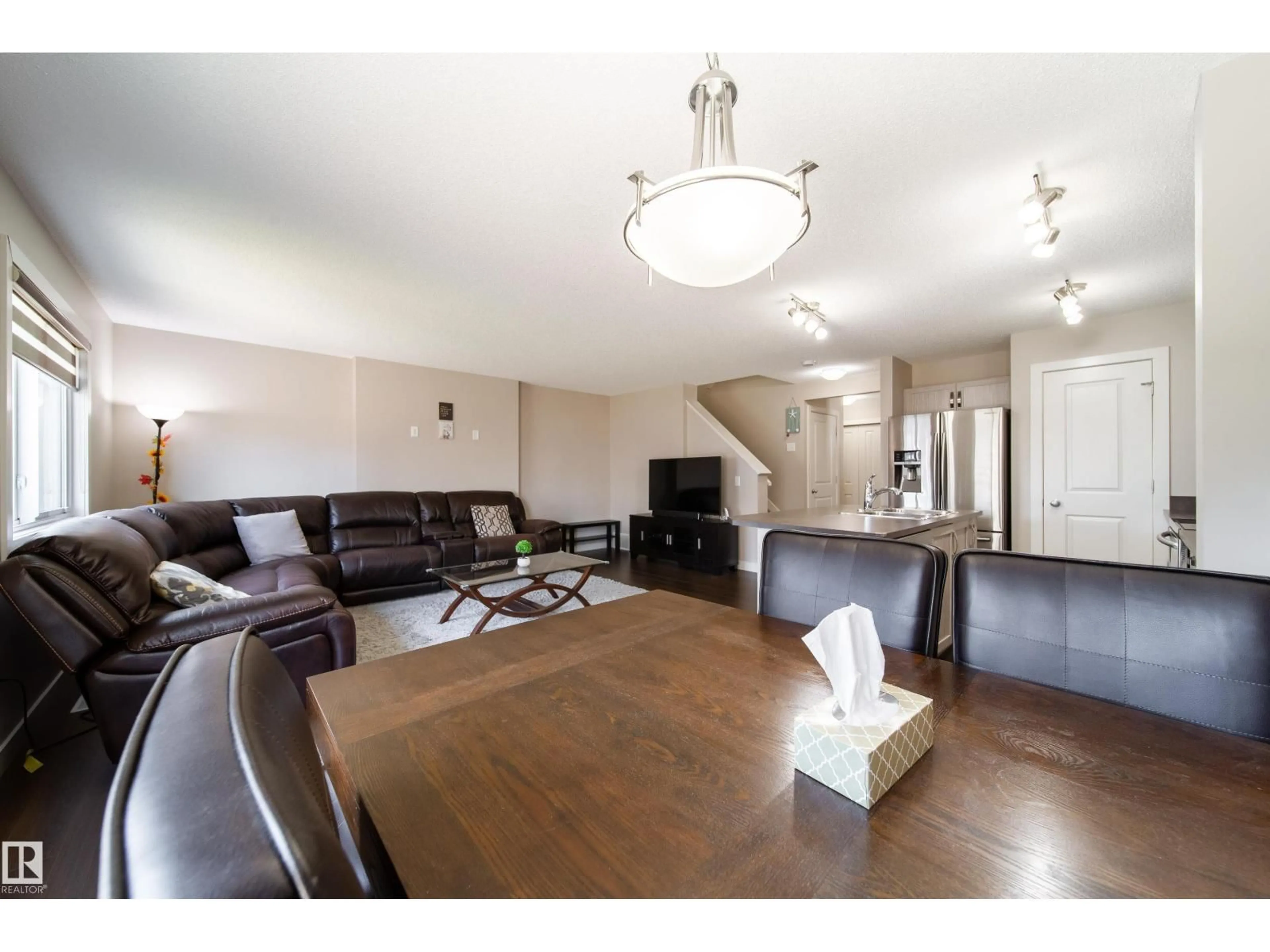 Living room with furniture, wood/laminate floor for NW - 1107 33A ST, Edmonton Alberta T6T2C4