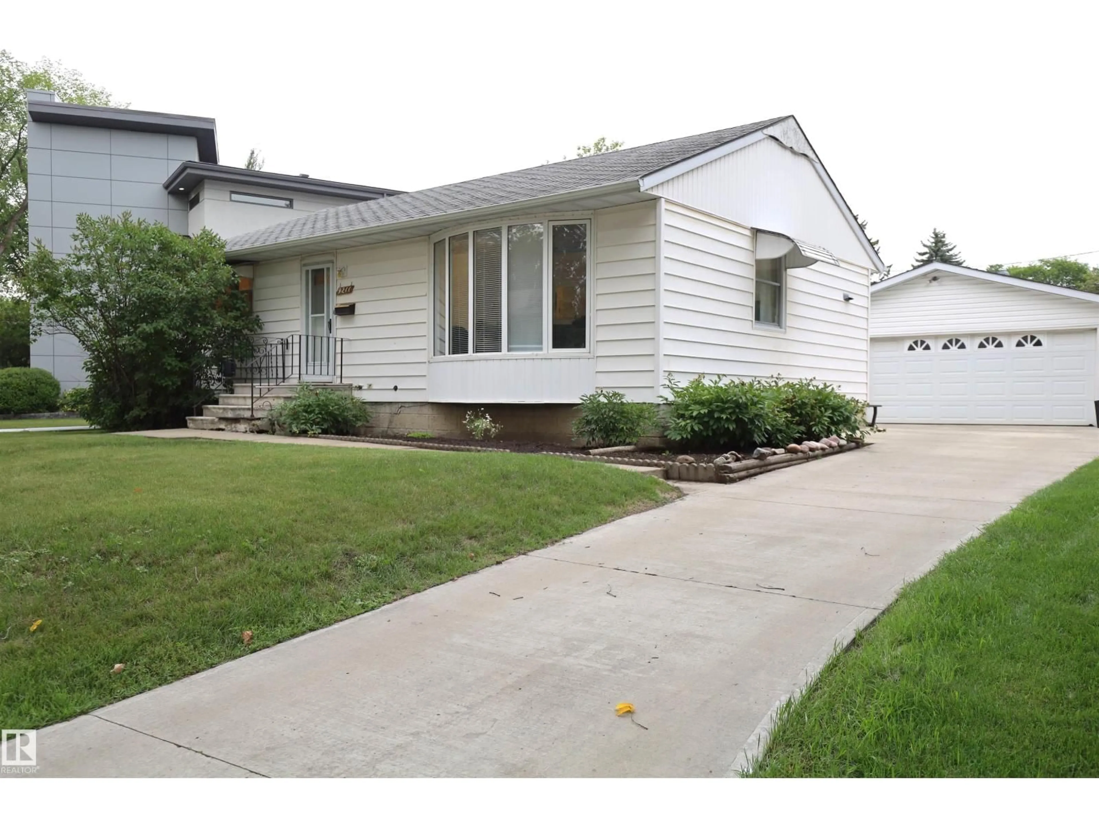 Home with vinyl exterior material, street for 9211 147 ST, Edmonton Alberta T5R0Y6