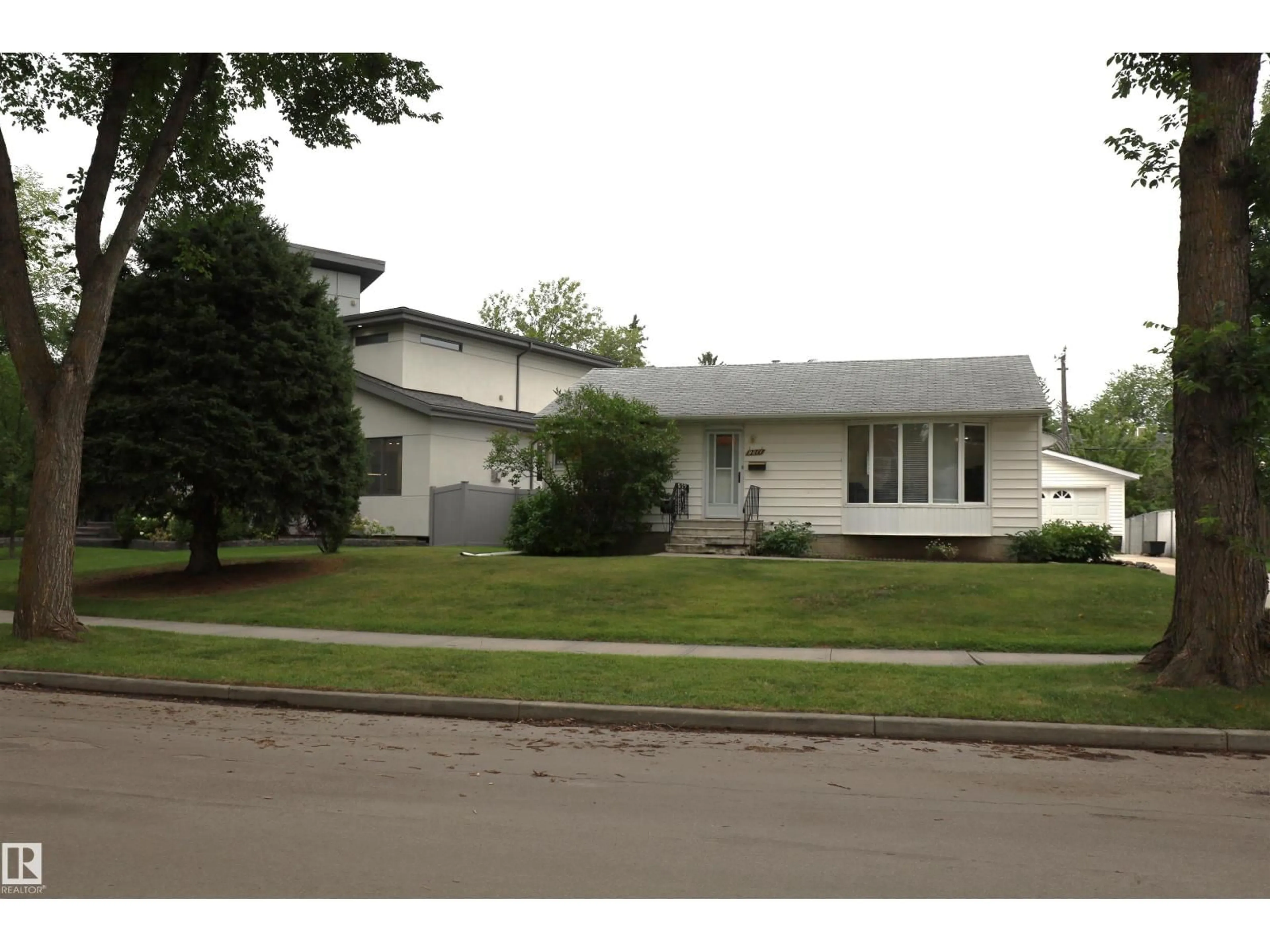 Home with vinyl exterior material, street for 9211 147 ST, Edmonton Alberta T5R0Y6