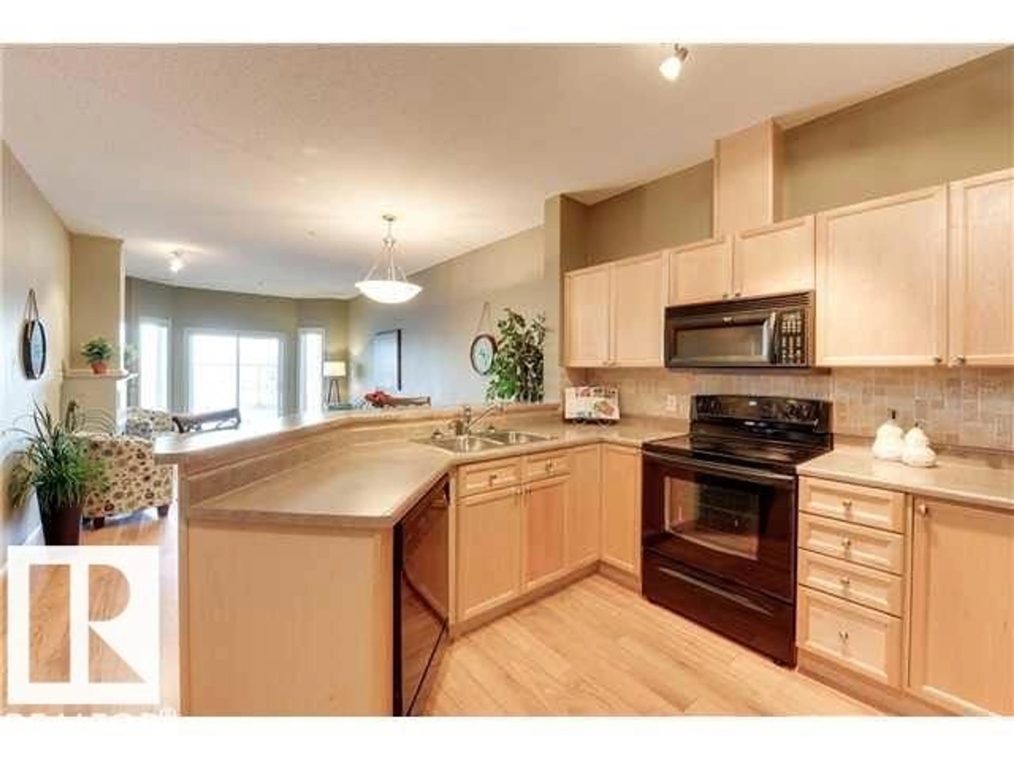 Open concept kitchen, wood/laminate floor for #112 - 4312 139 AV, Edmonton Alberta T5Y3J4