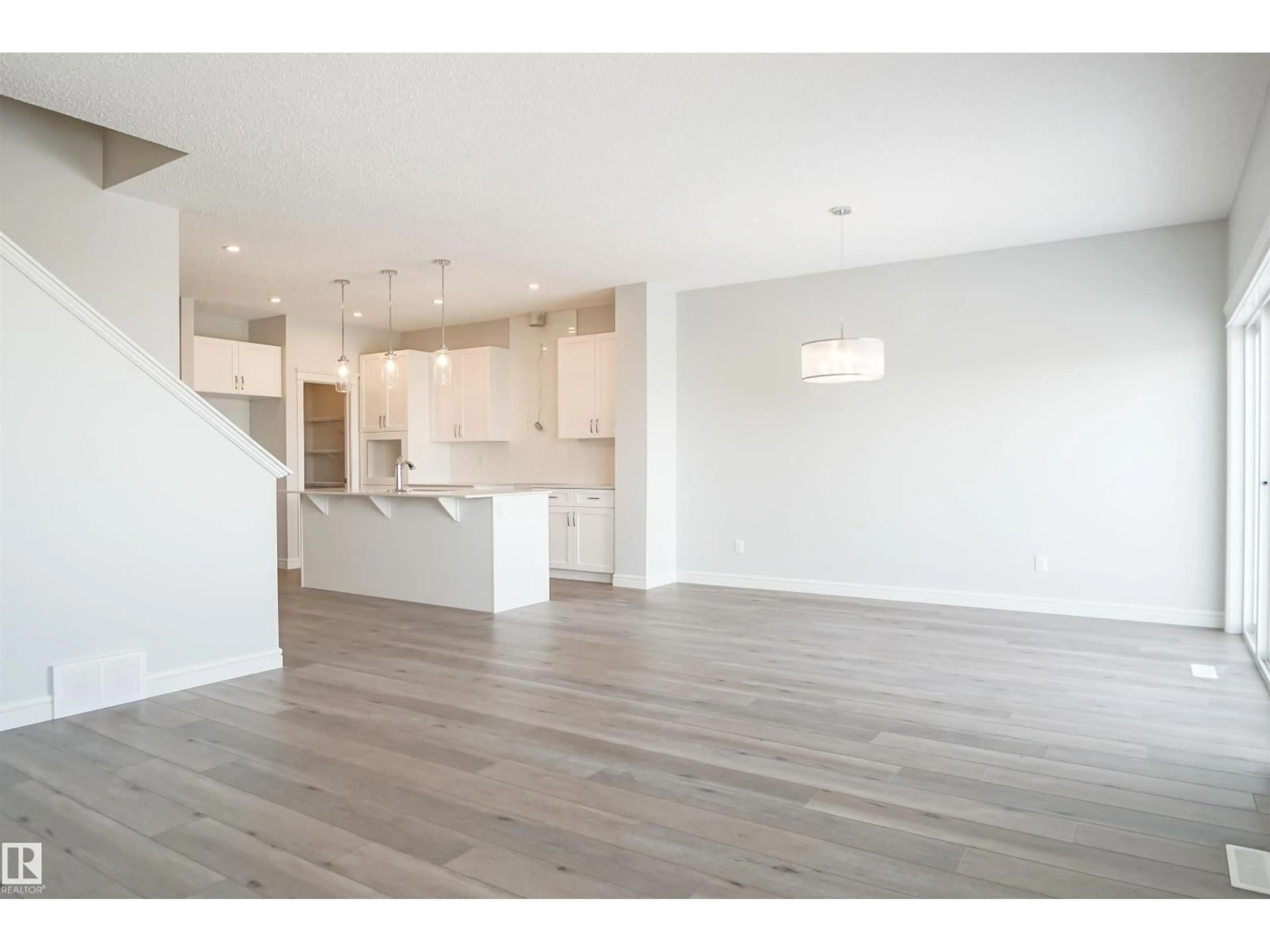 Open concept kitchen, wood/laminate floor for NE - 16531 3 ST, Edmonton Alberta T5Y4E9