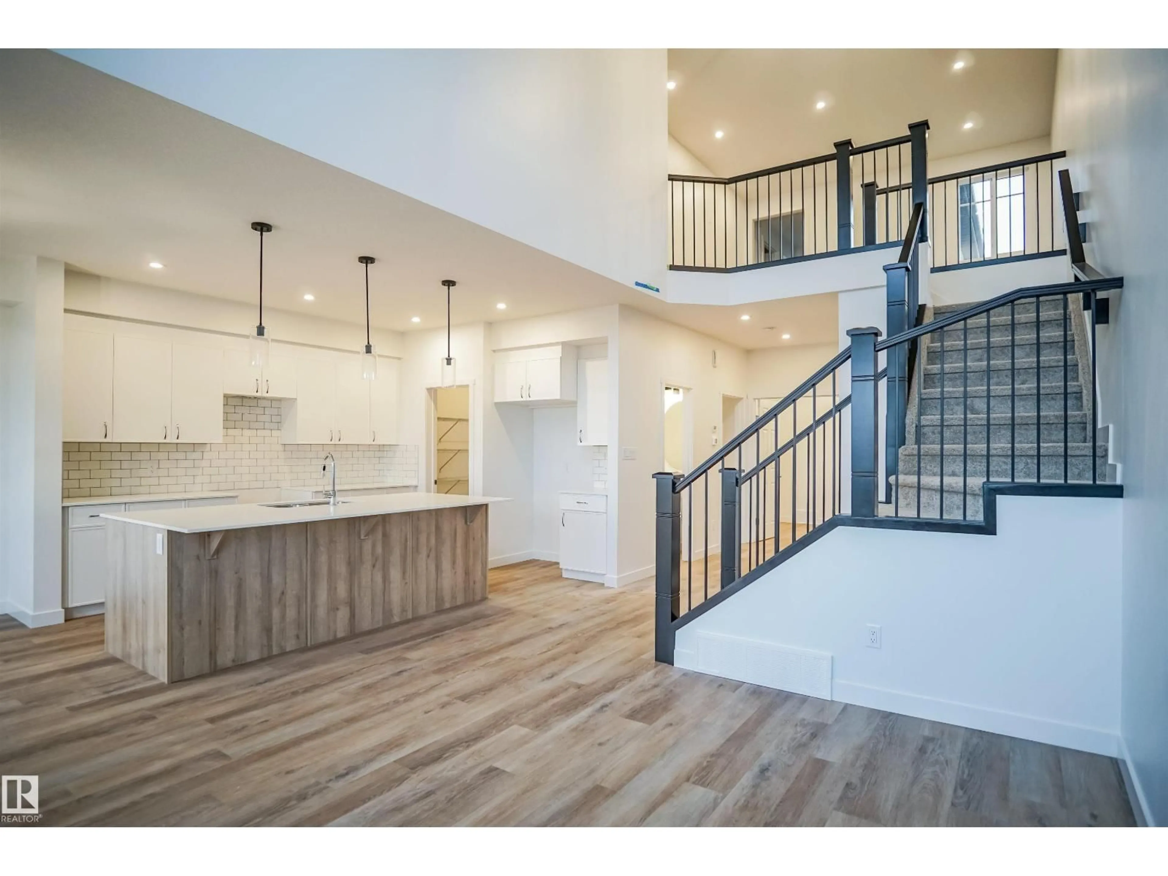 Open concept kitchen, wood/laminate floor for 1323 11 AV, Edmonton Alberta T6W4X8