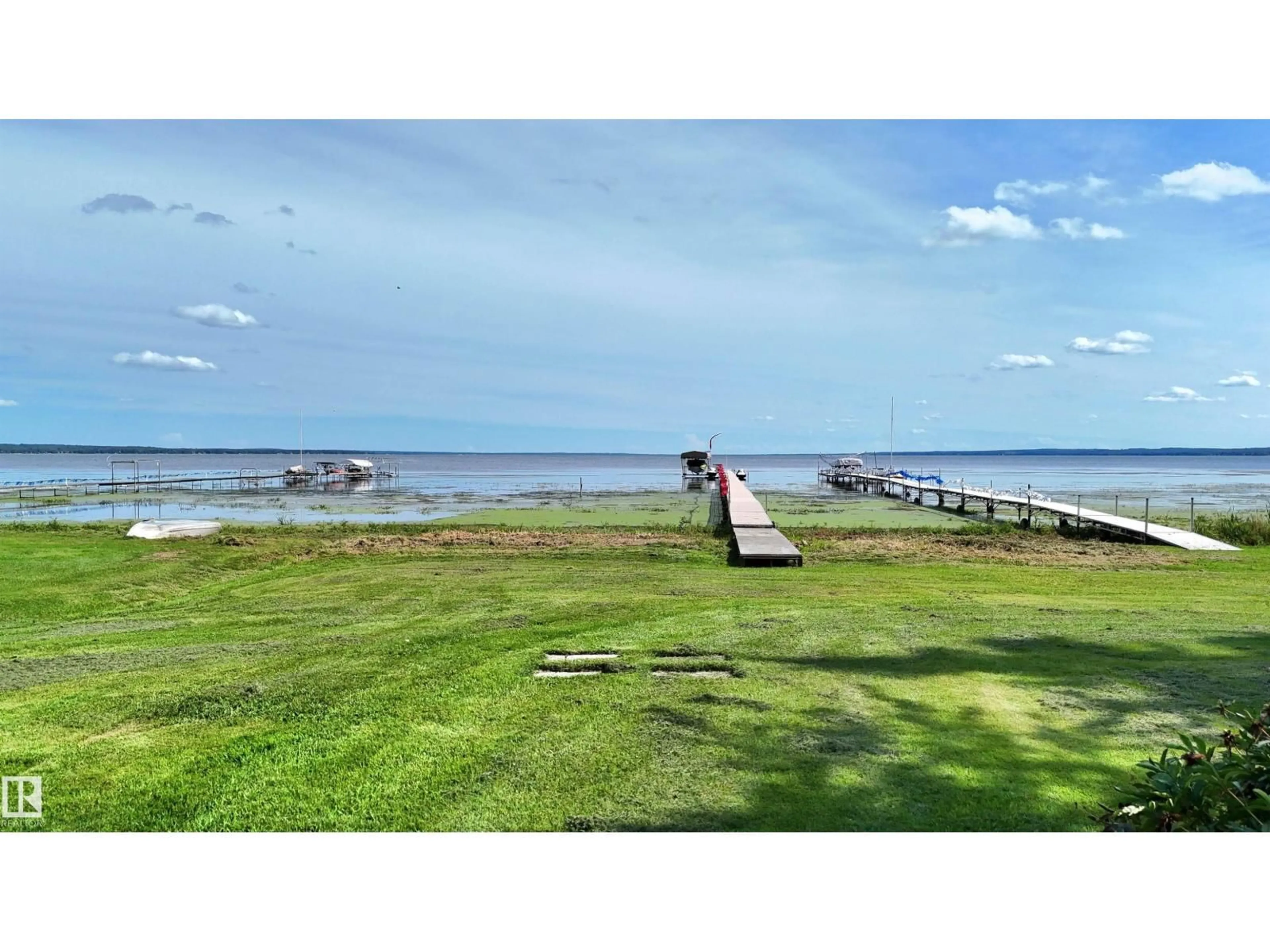 A pic from outside/outdoor area/front of a property/back of a property/a pic from drone, water/lake/river/ocean view for 2001 - 110 TWP474 MITCHELL BEACH, Rural Leduc County Alberta T0C2P0