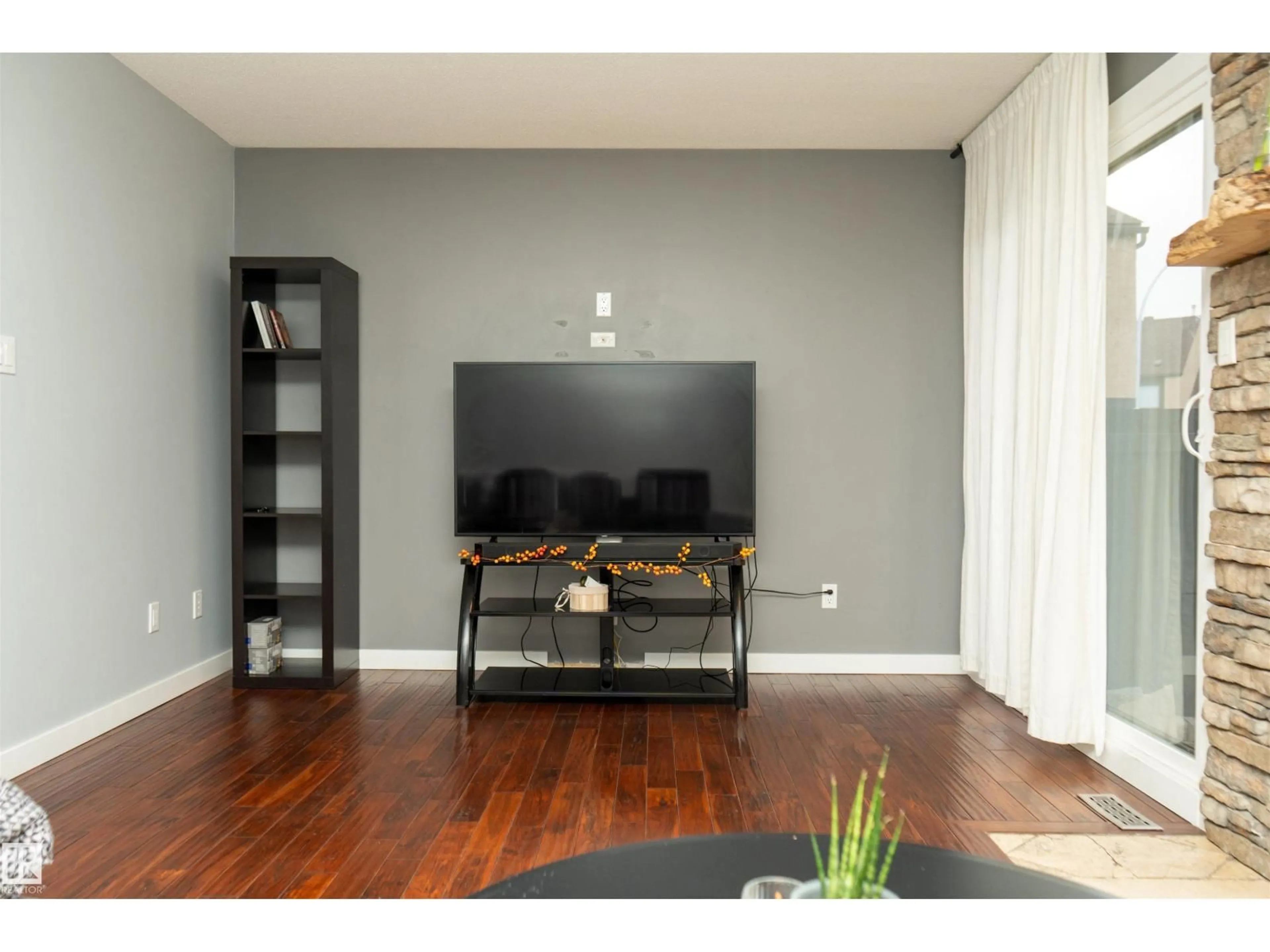 Living room with furniture, wood/laminate floor for 12070 25 AV, Edmonton Alberta T6J4L3