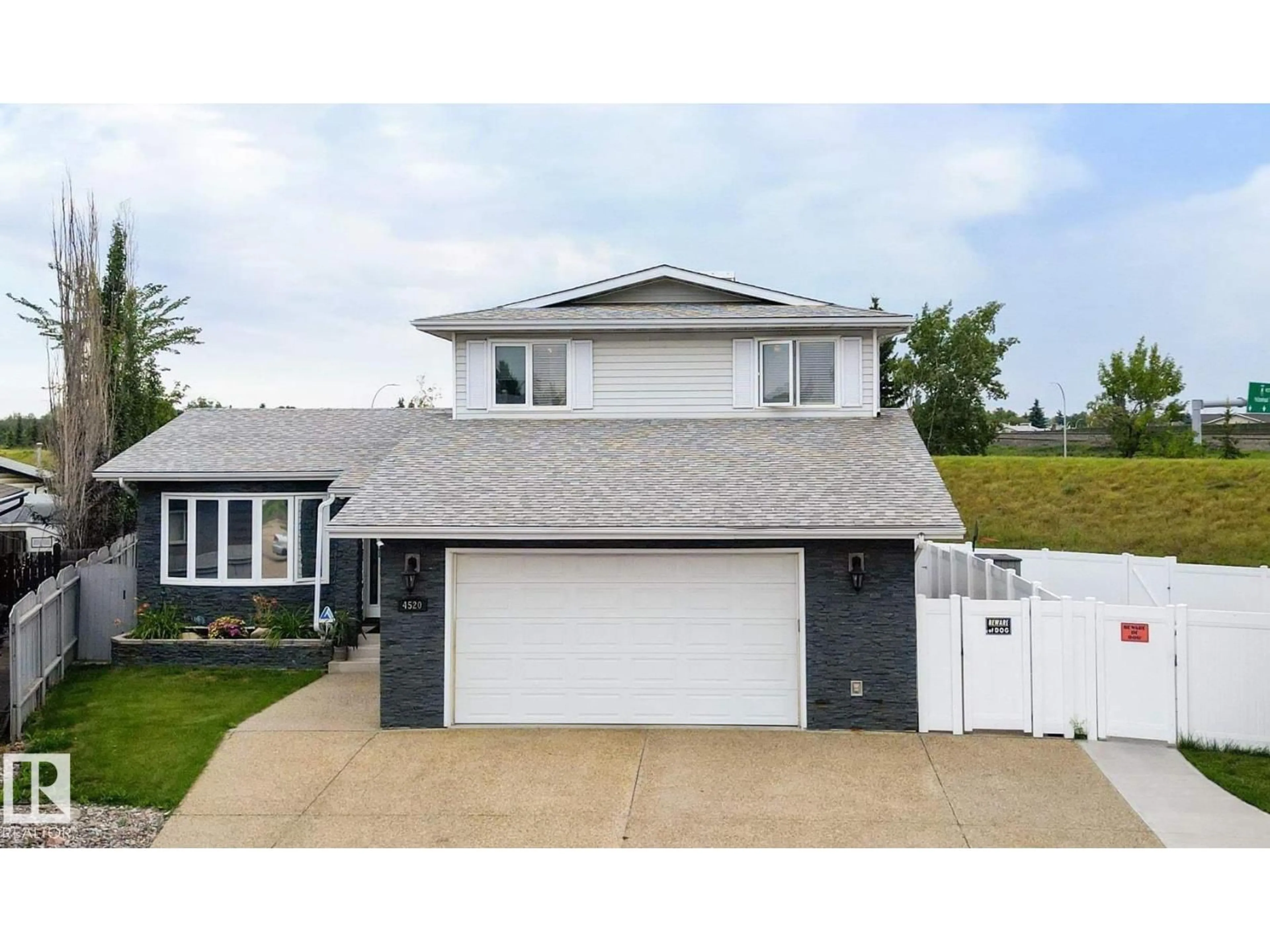 Home with vinyl exterior material, street for 4520 124 AV, Edmonton Alberta T5W5B8
