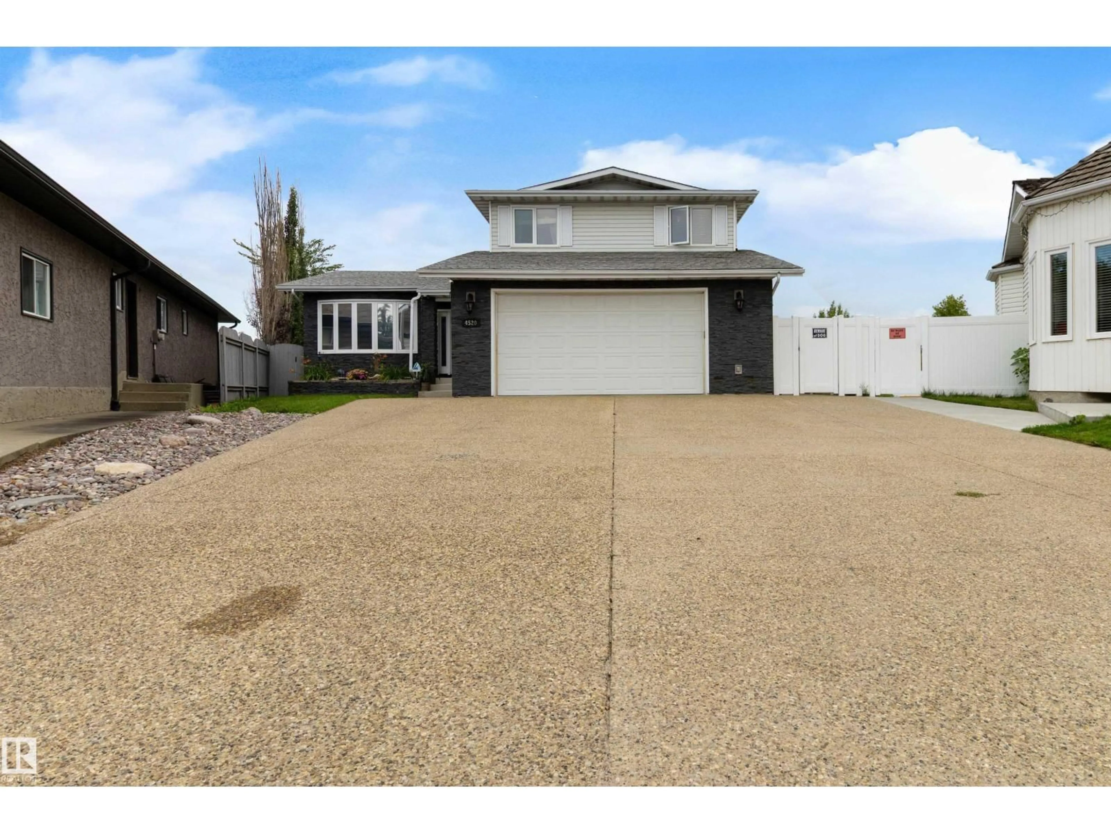 Home with vinyl exterior material, street for 4520 124 AV, Edmonton Alberta T5W5B8