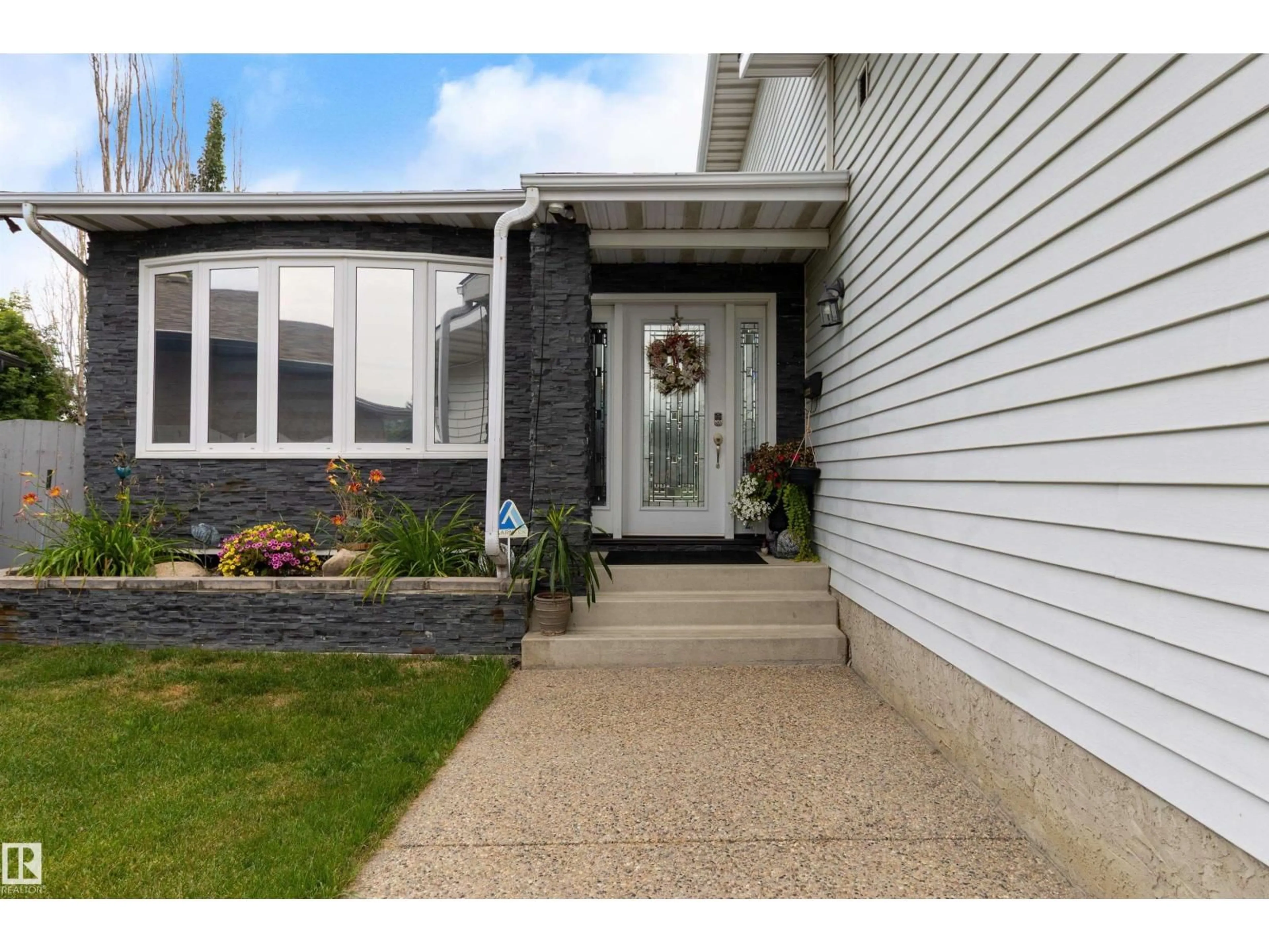 Home with vinyl exterior material, street for 4520 124 AV, Edmonton Alberta T5W5B8