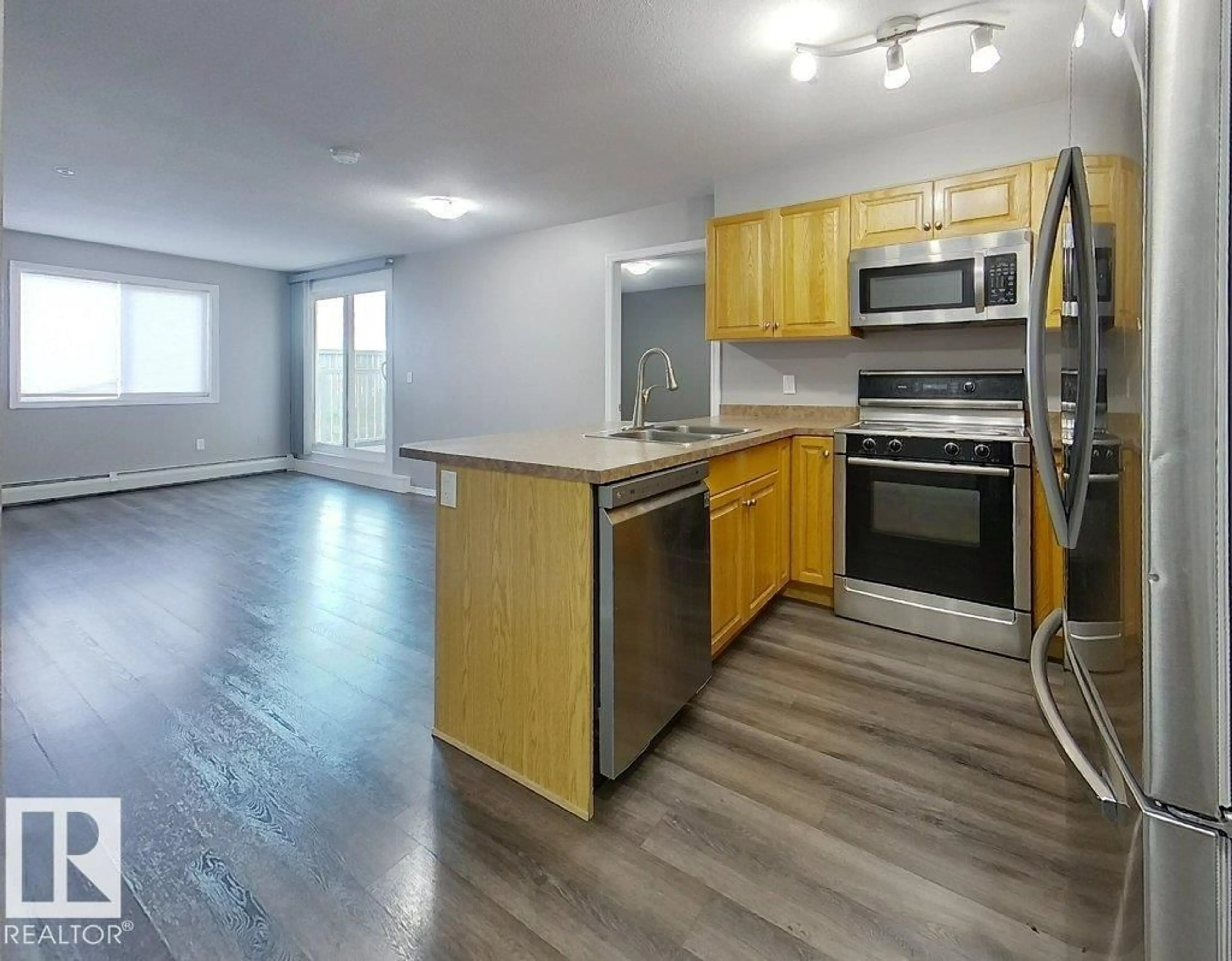 Open concept kitchen, wood/laminate floor for #111 - 4309 33 ST, Stony Plain Alberta T7Z0C4