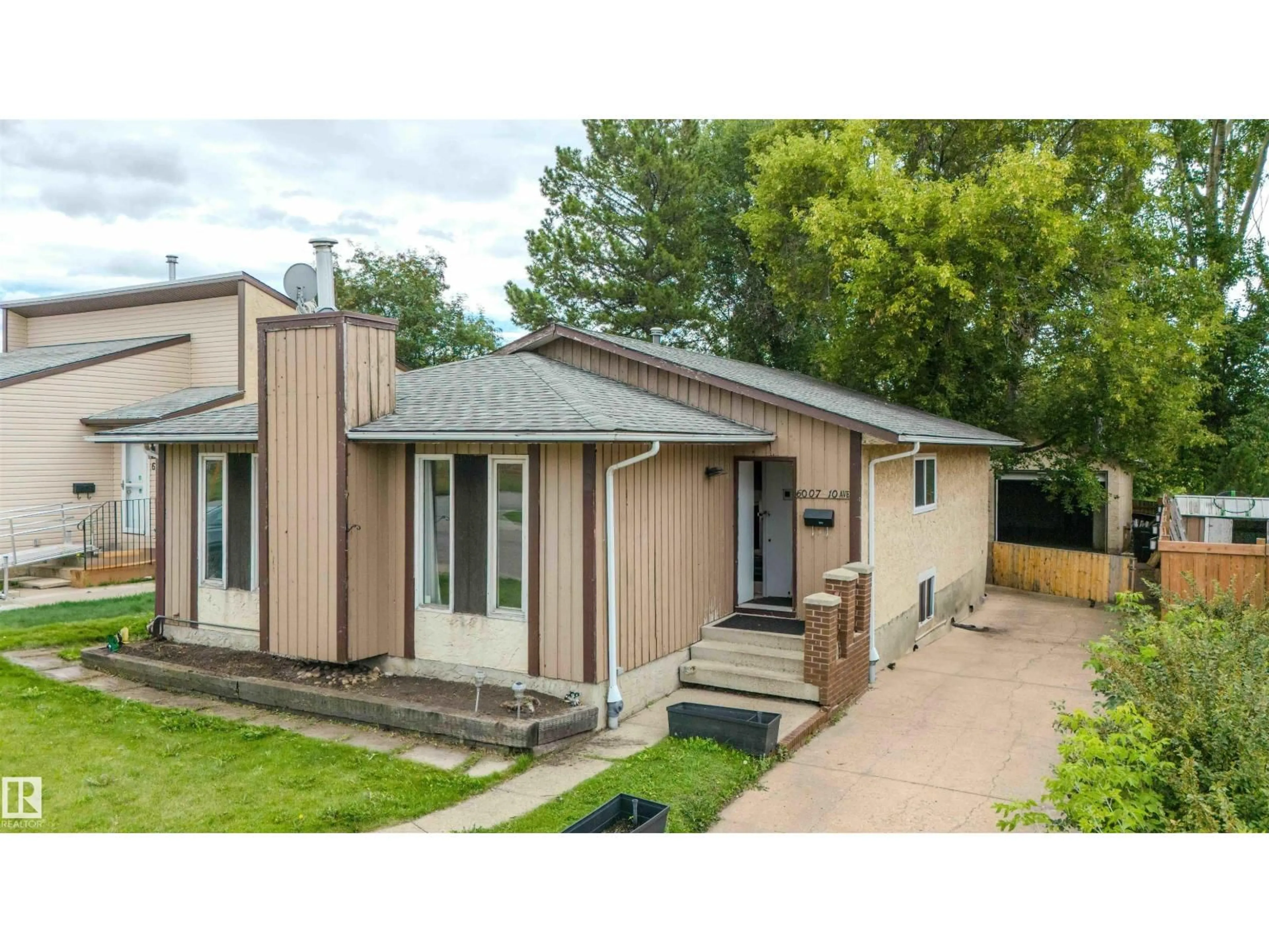 Home with vinyl exterior material, street for 6007 10 AV, Edmonton Alberta T6L3A5