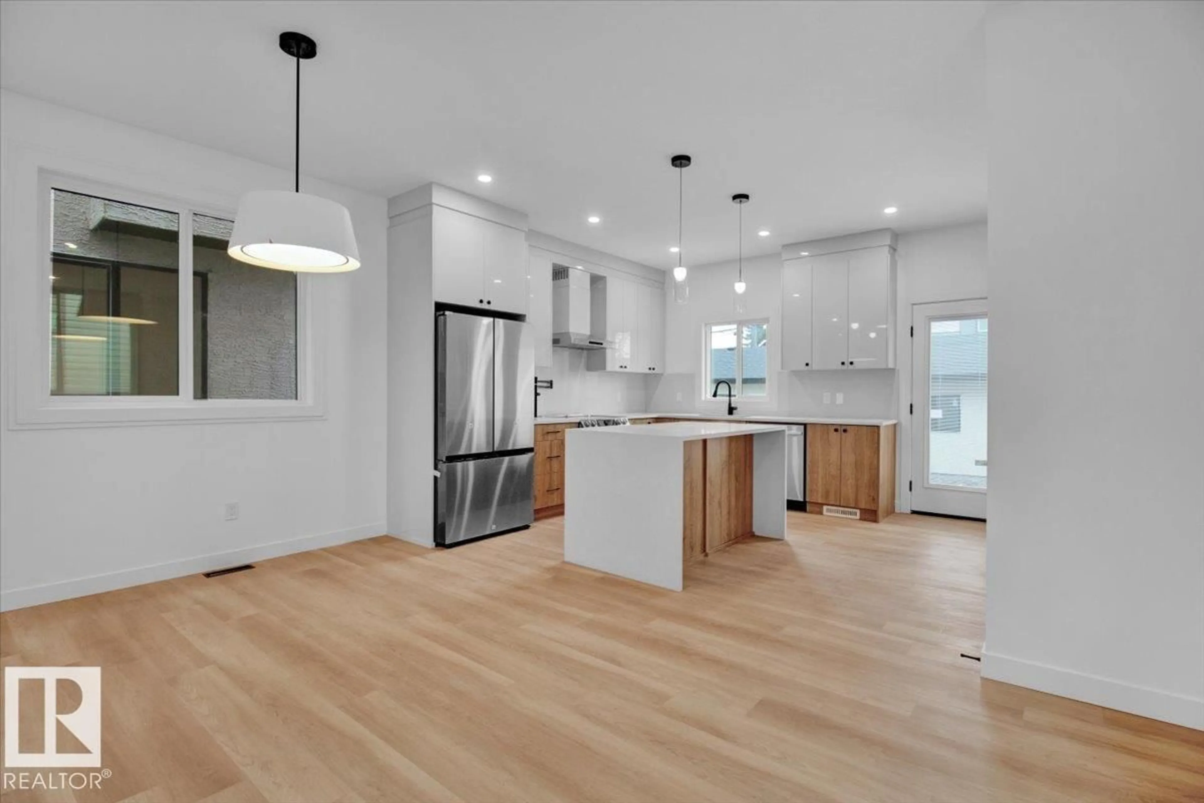 Open concept kitchen, wood/laminate floor for 11126 132 ST, Edmonton Alberta T5M1E5