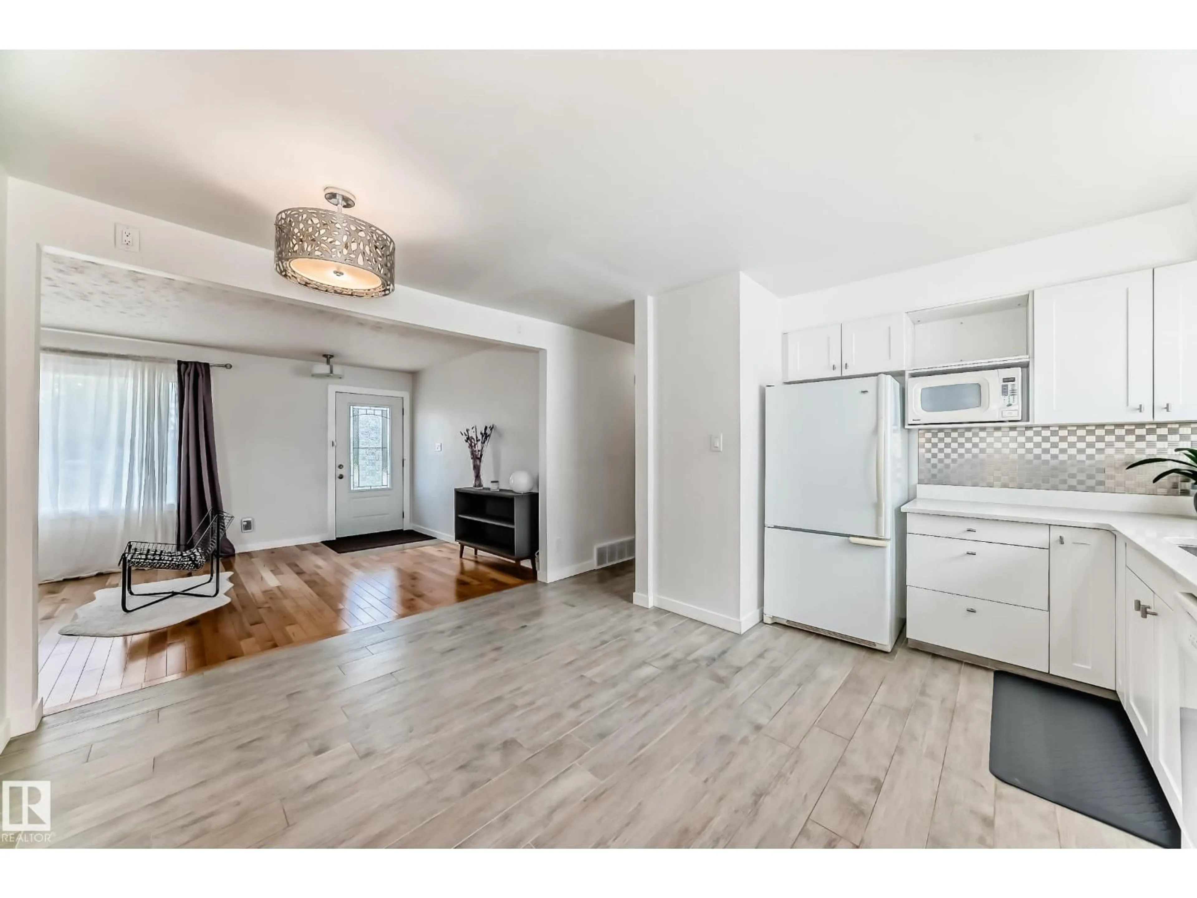 Open concept kitchen, wood/laminate floor for 13424 82 ST, Edmonton Alberta T5E2V2