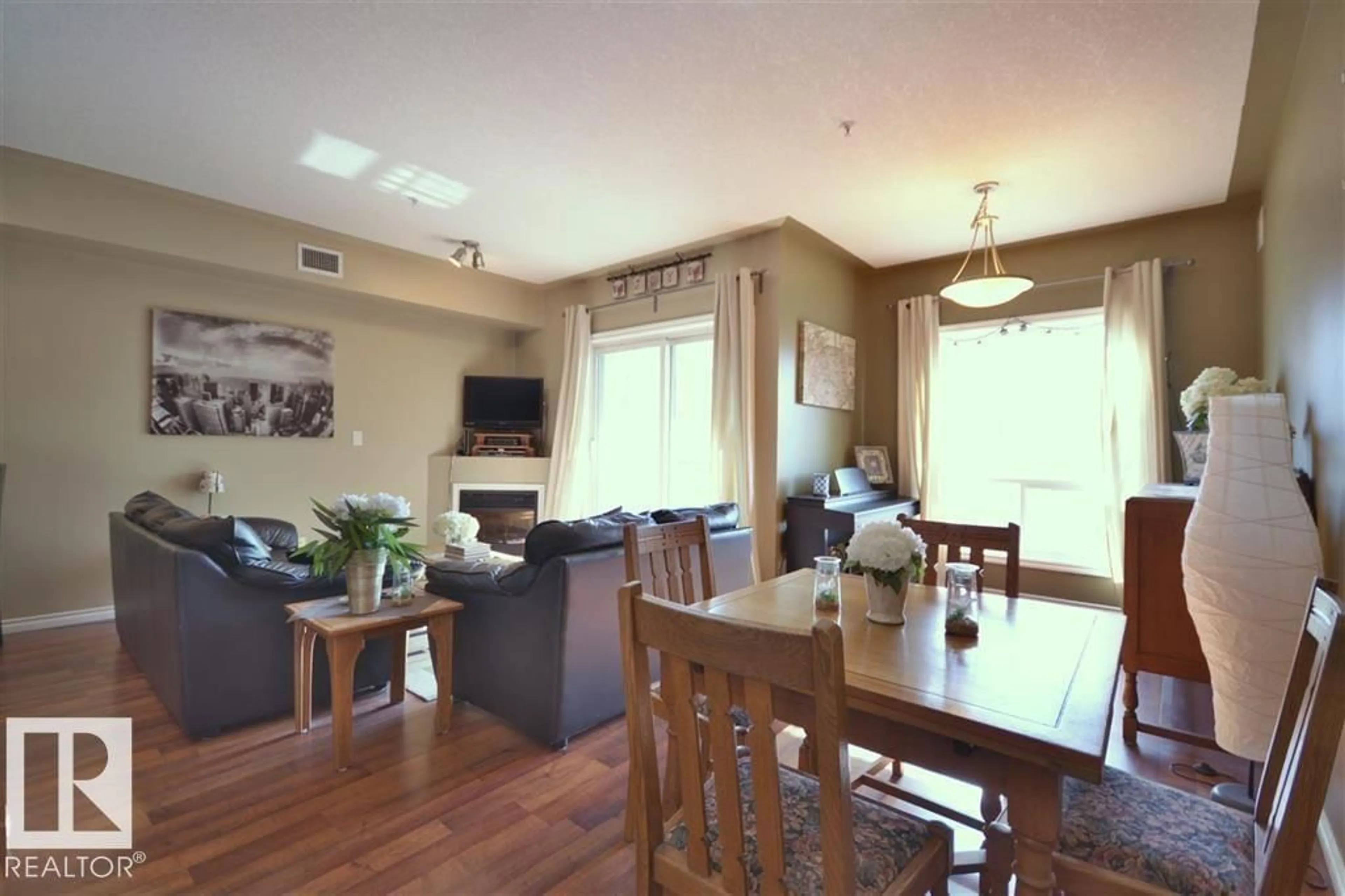 Living room with furniture, wood/laminate floor for 310 - 10606 102 AV, Edmonton Alberta T5J5E9