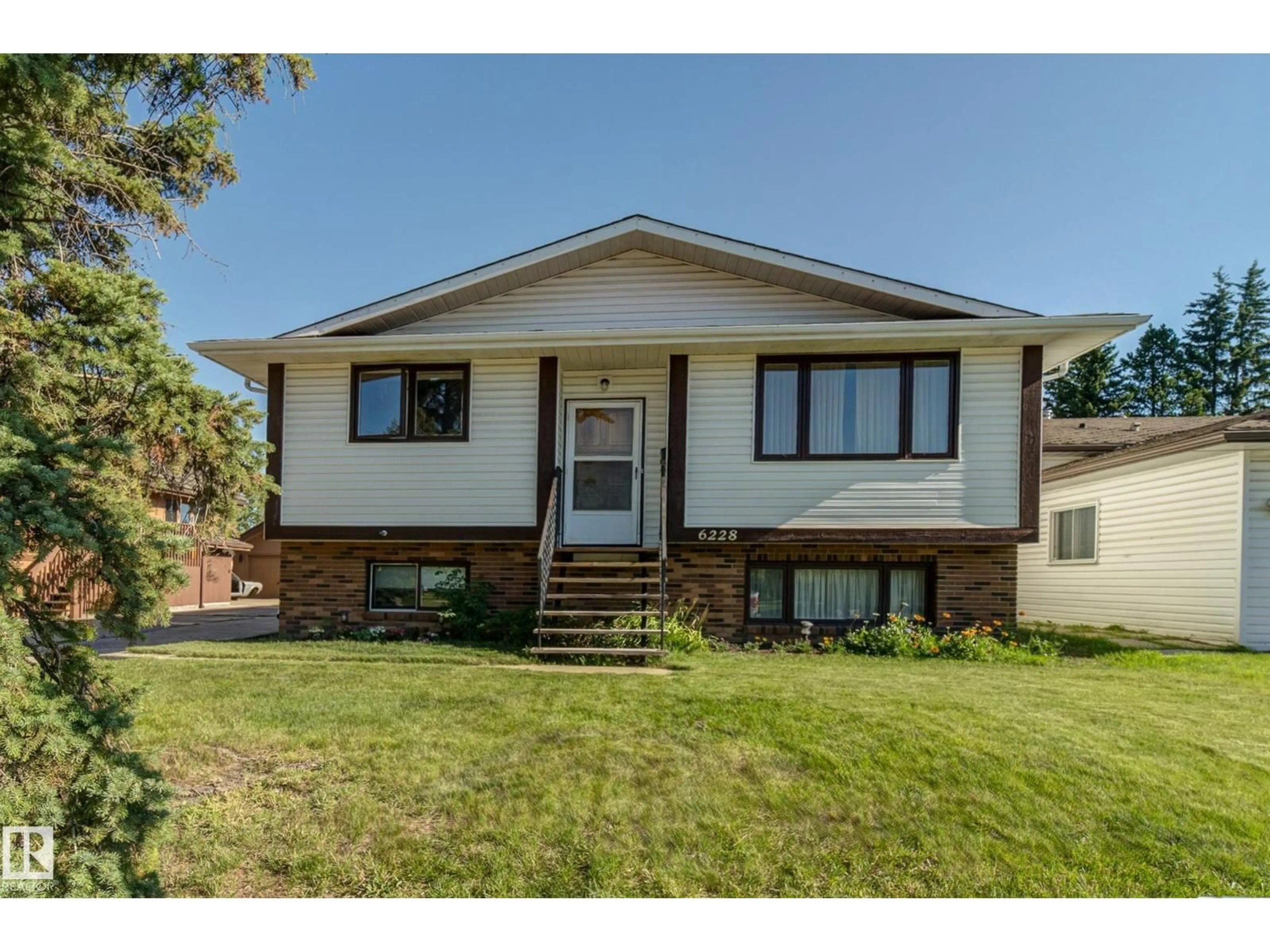 Home with vinyl exterior material, street for 6228 13 AV, Edmonton Alberta T6L2E6