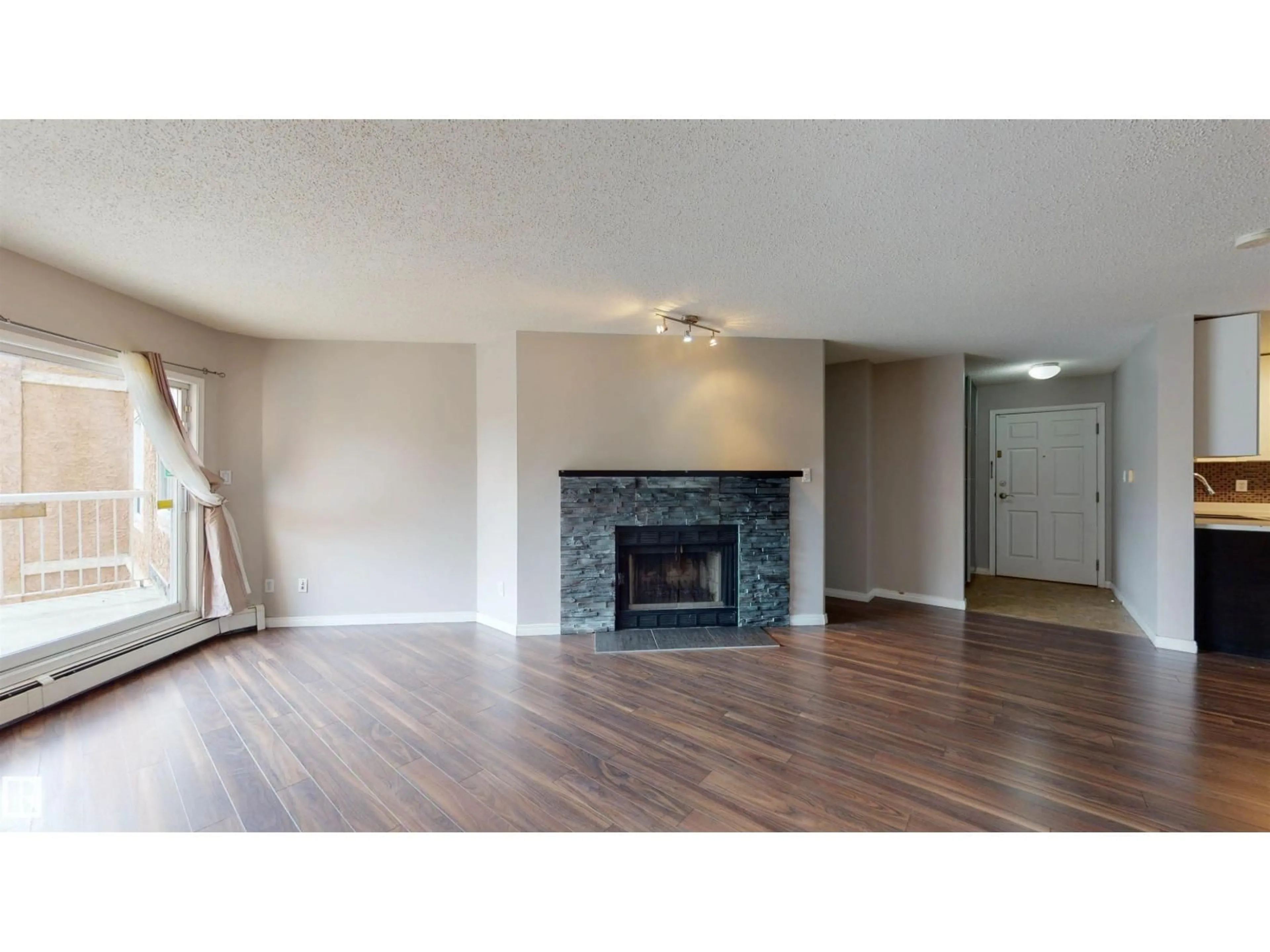 Living room with furniture, wood/laminate floor for 9010 - 316 106 AV, Edmonton Alberta T5H4K3