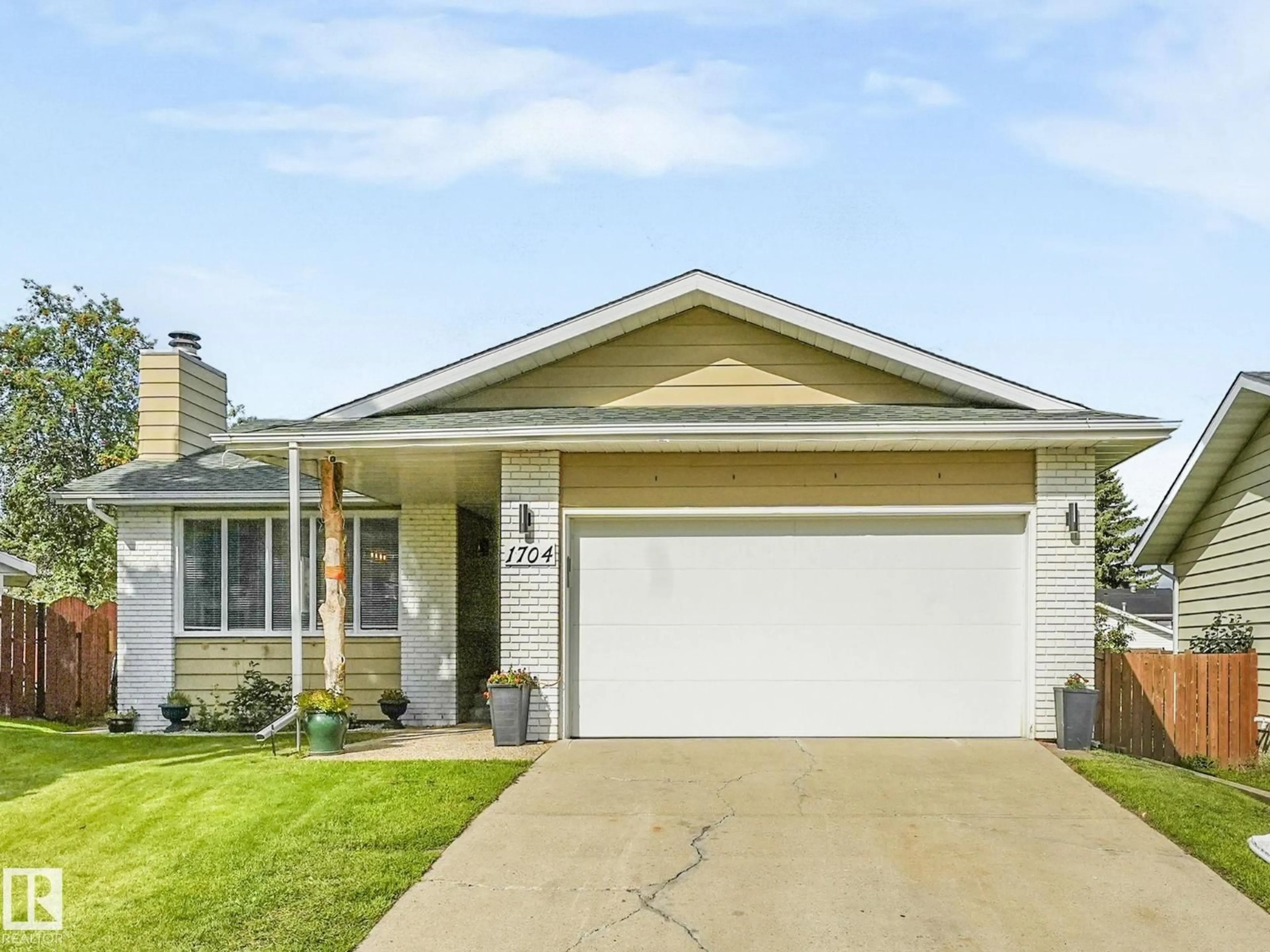 Home with vinyl exterior material, street for 1704 53 ST, Edmonton Alberta T6R1K4