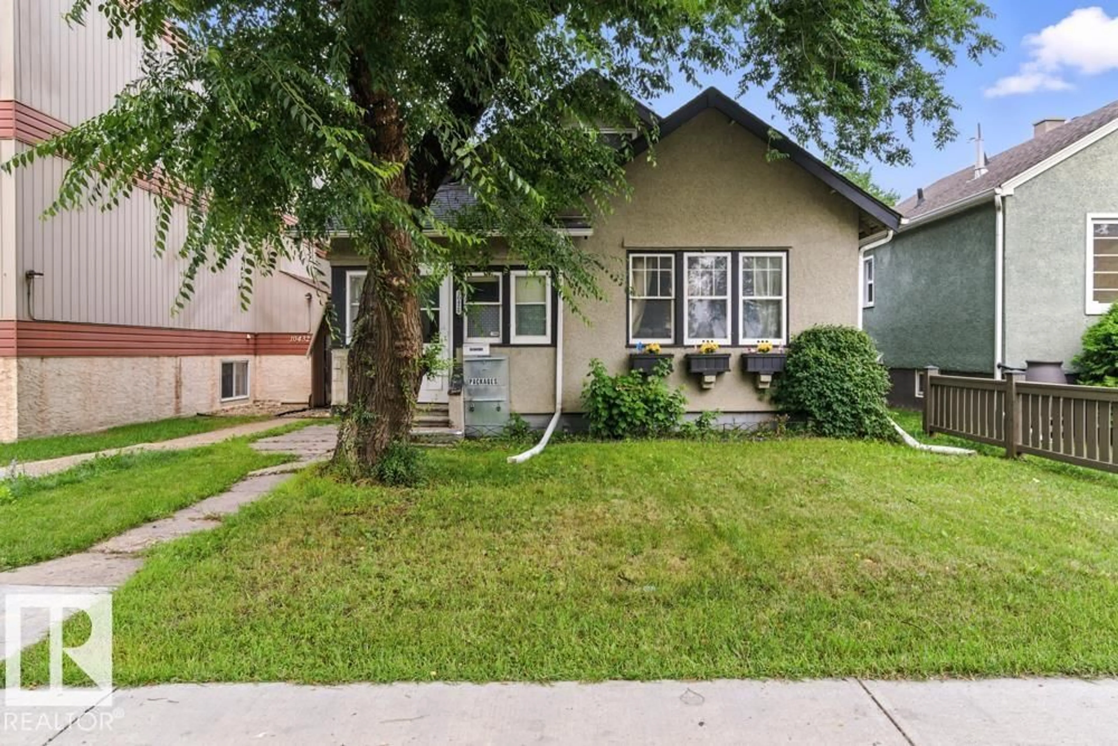 Home with vinyl exterior material, street for 10428 76 AV, Edmonton Alberta T6E1L1