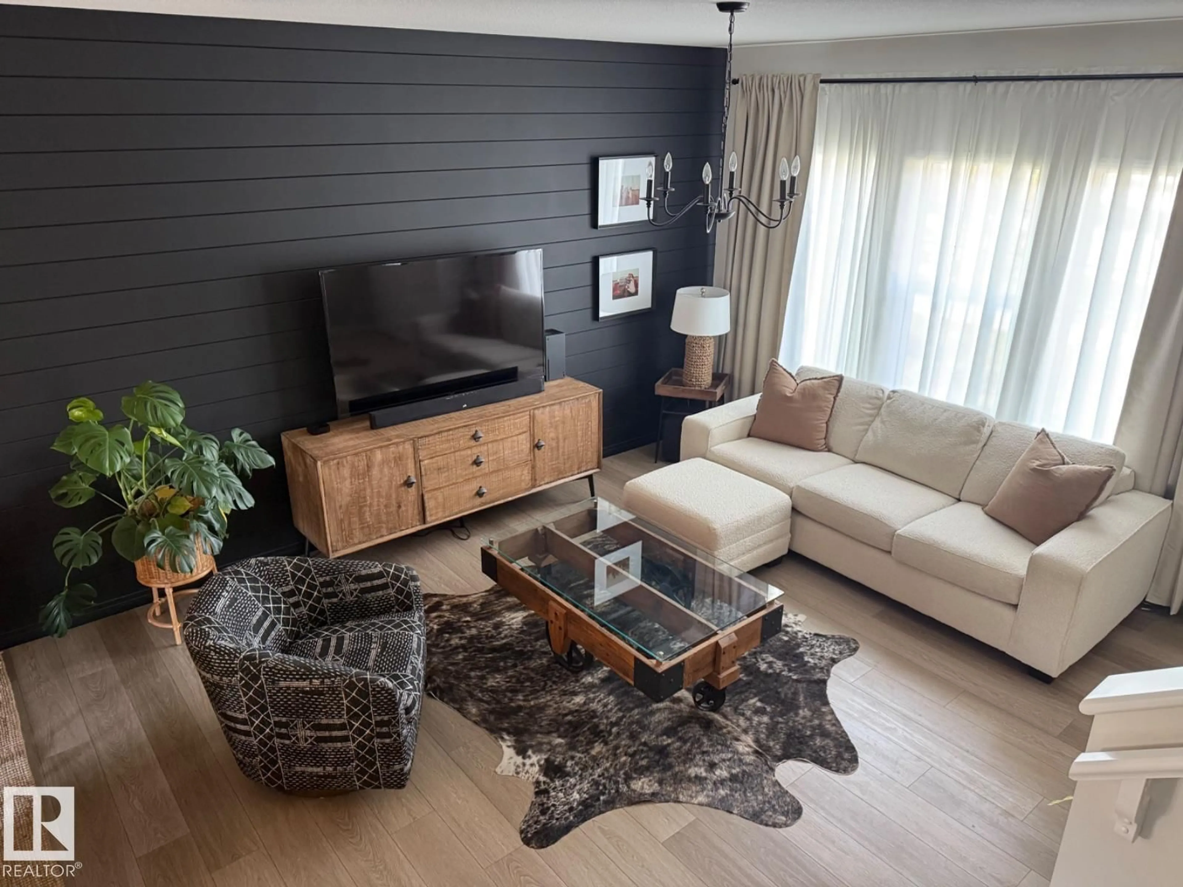Living room with furniture, wood/laminate floor for 4316 38 ST, Beaumont Alberta T4X1A1