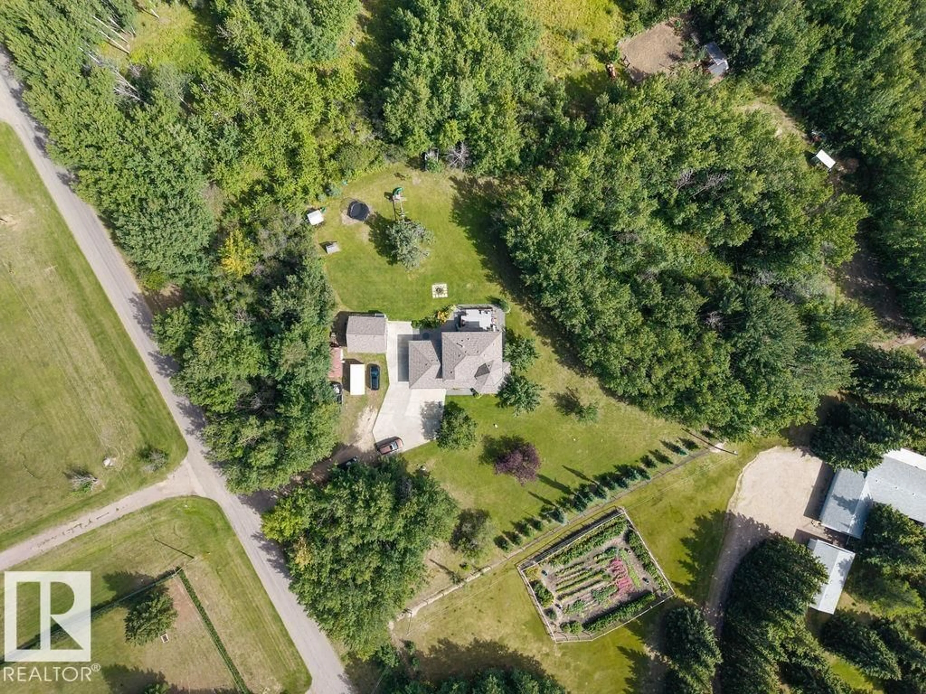 A pic from outside/outdoor area/front of a property/back of a property/a pic from drone, forest/trees view for 18 - 54106 RGE ROAD 275, Rural Parkland County Alberta T7X3V3