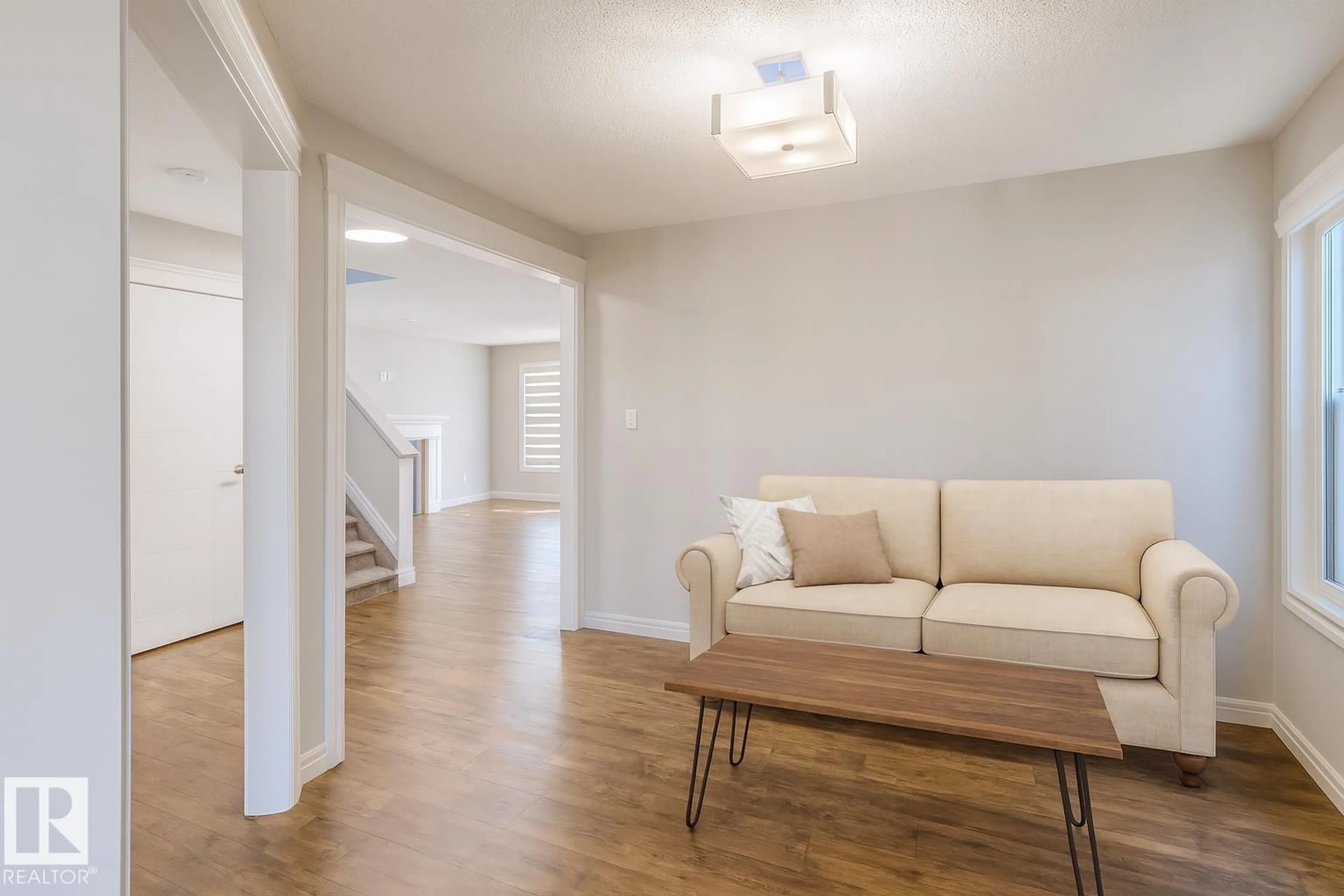 Living room with furniture, wood/laminate floor for SW SW - 1627 158 STREET, Edmonton Alberta T6W3E7