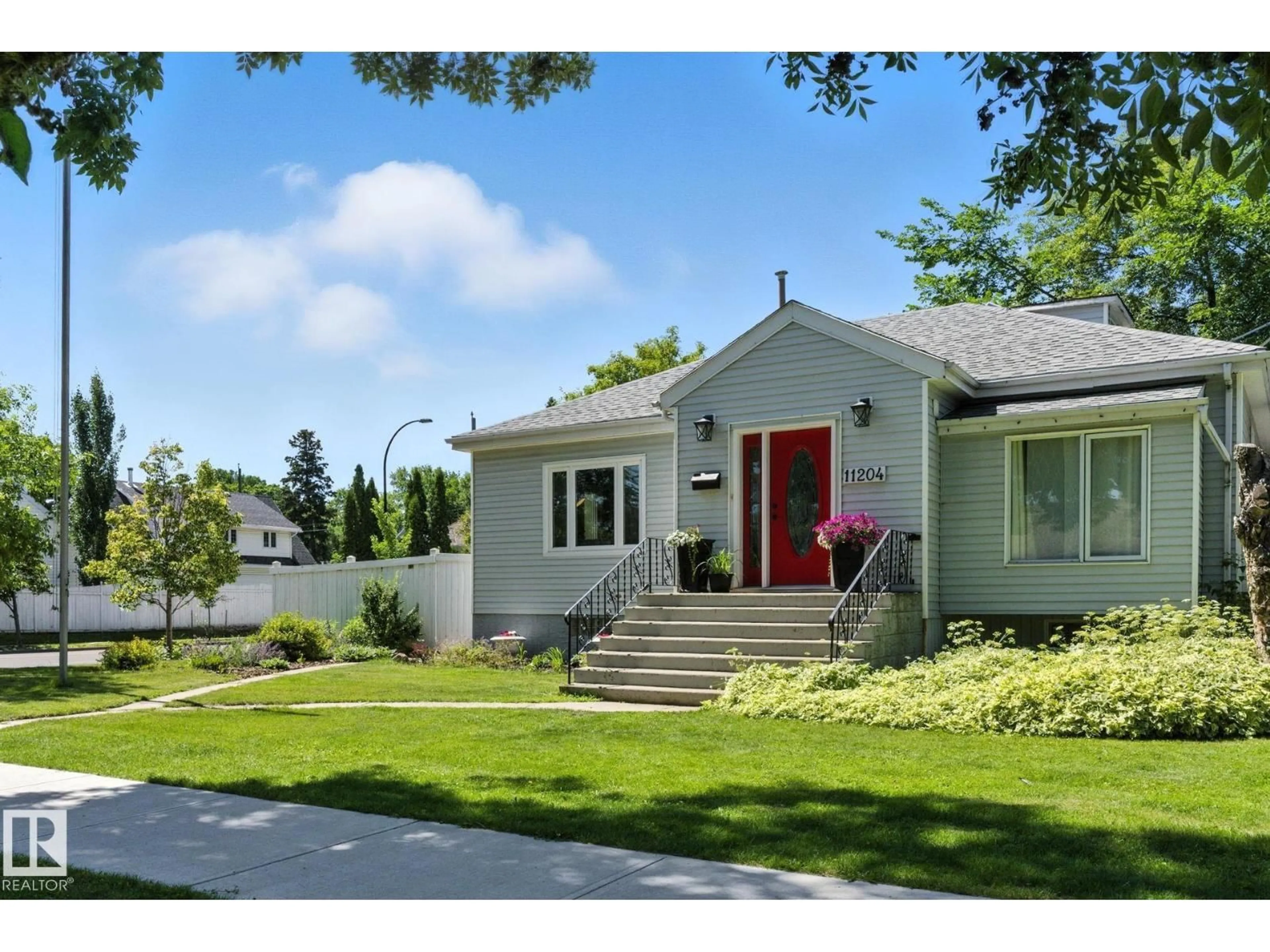 Home with vinyl exterior material, street for NW - 11204 61 ST, Edmonton Alberta T5W4A5