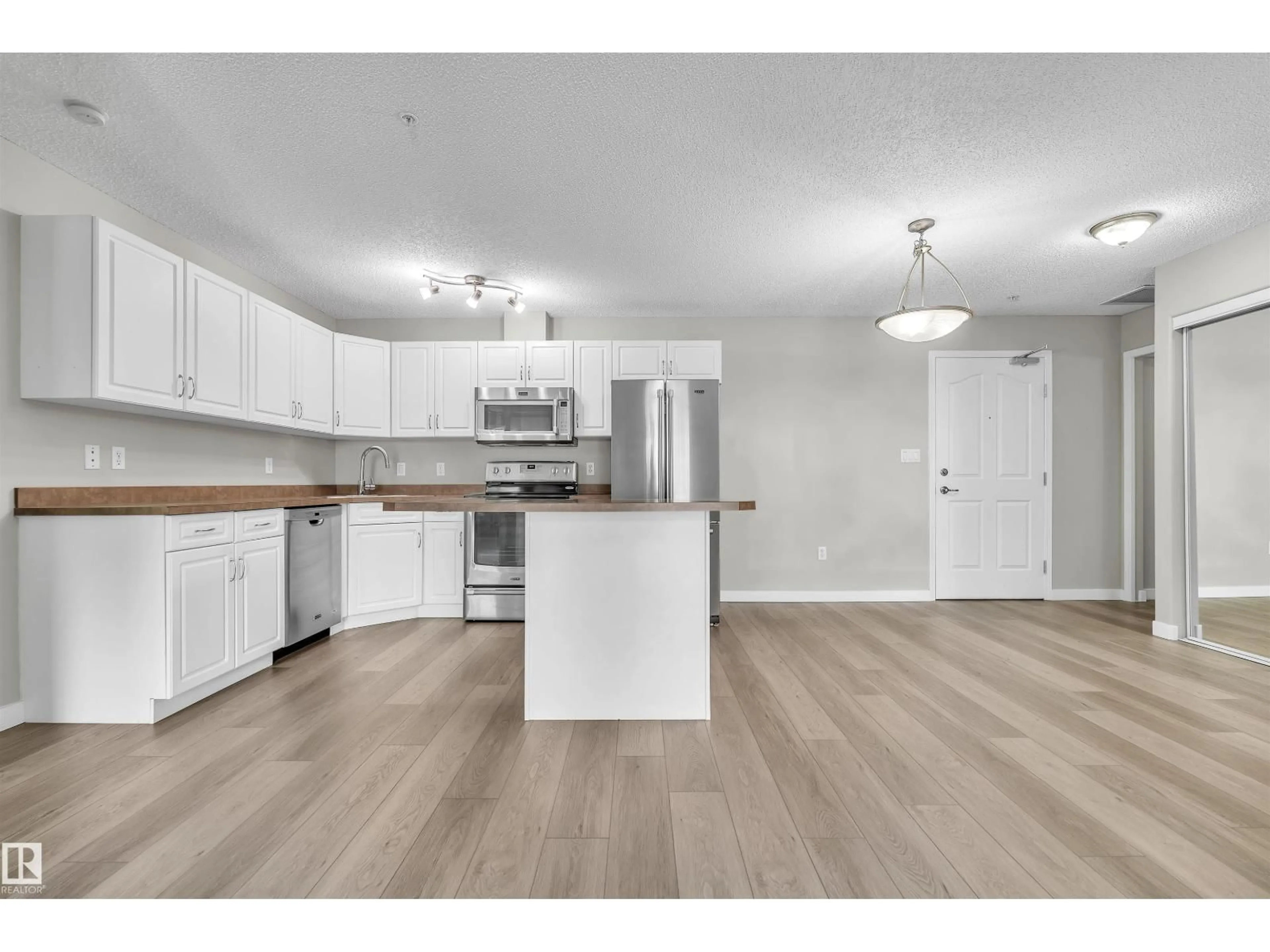 Open concept kitchen, wood/laminate floor for #303 - 279 SUDER GREENS DR, Edmonton Alberta T5T6X6