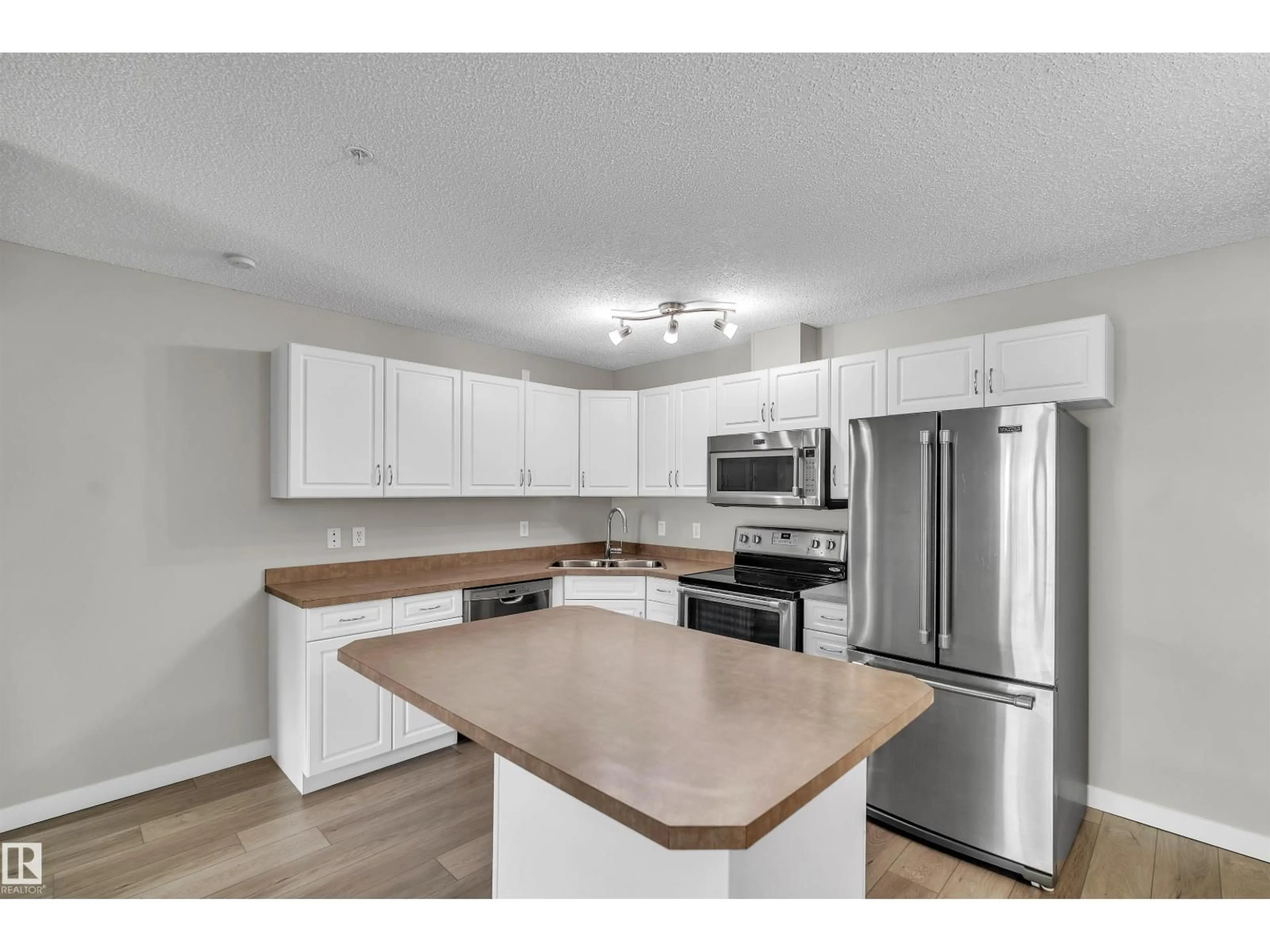 Open concept kitchen, wood/laminate floor for #303 - 279 SUDER GREENS DR, Edmonton Alberta T5T6X6