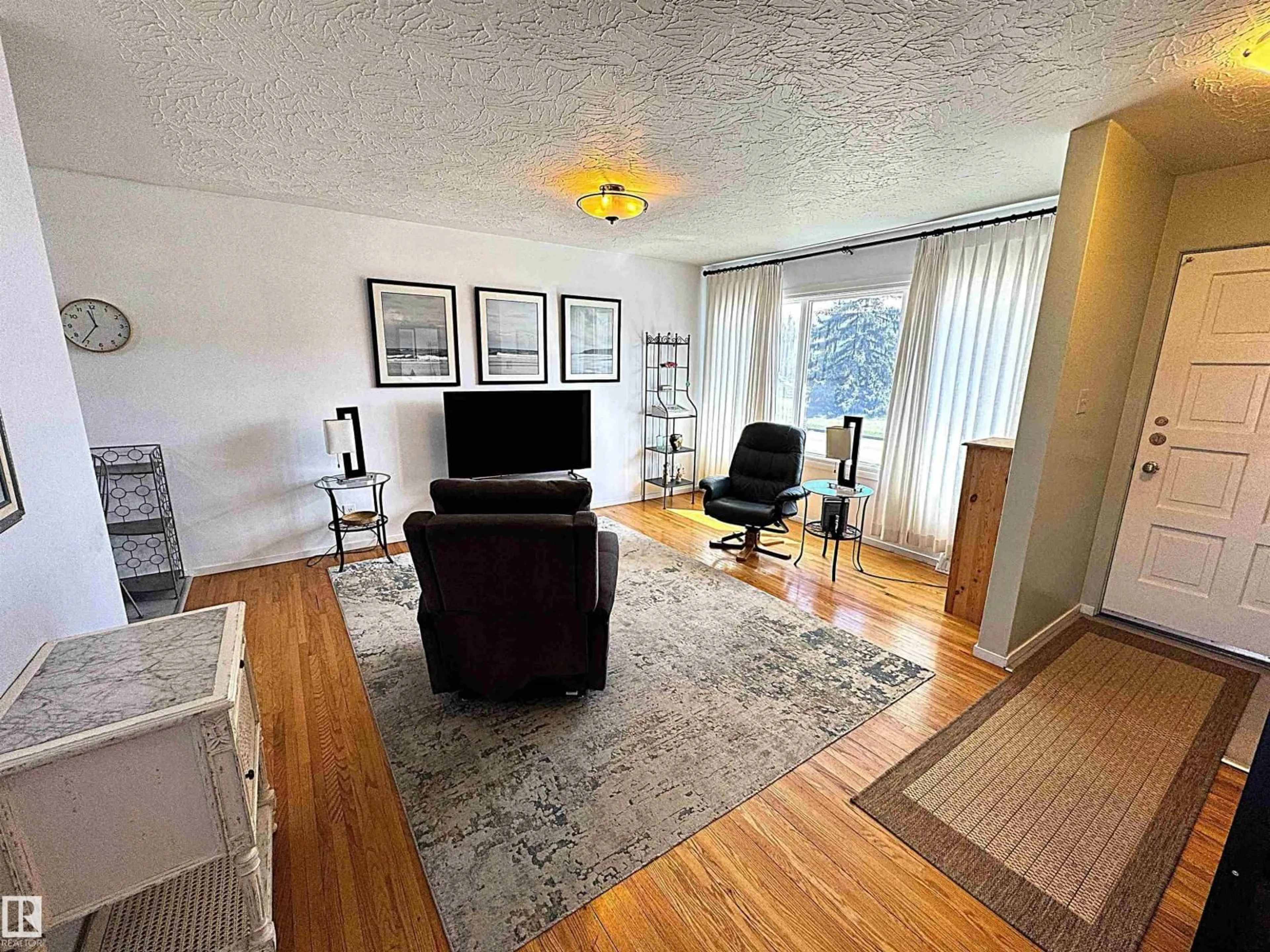 Living room with furniture, wood/laminate floor for 7336 75 ST, Edmonton Alberta T6C2E8