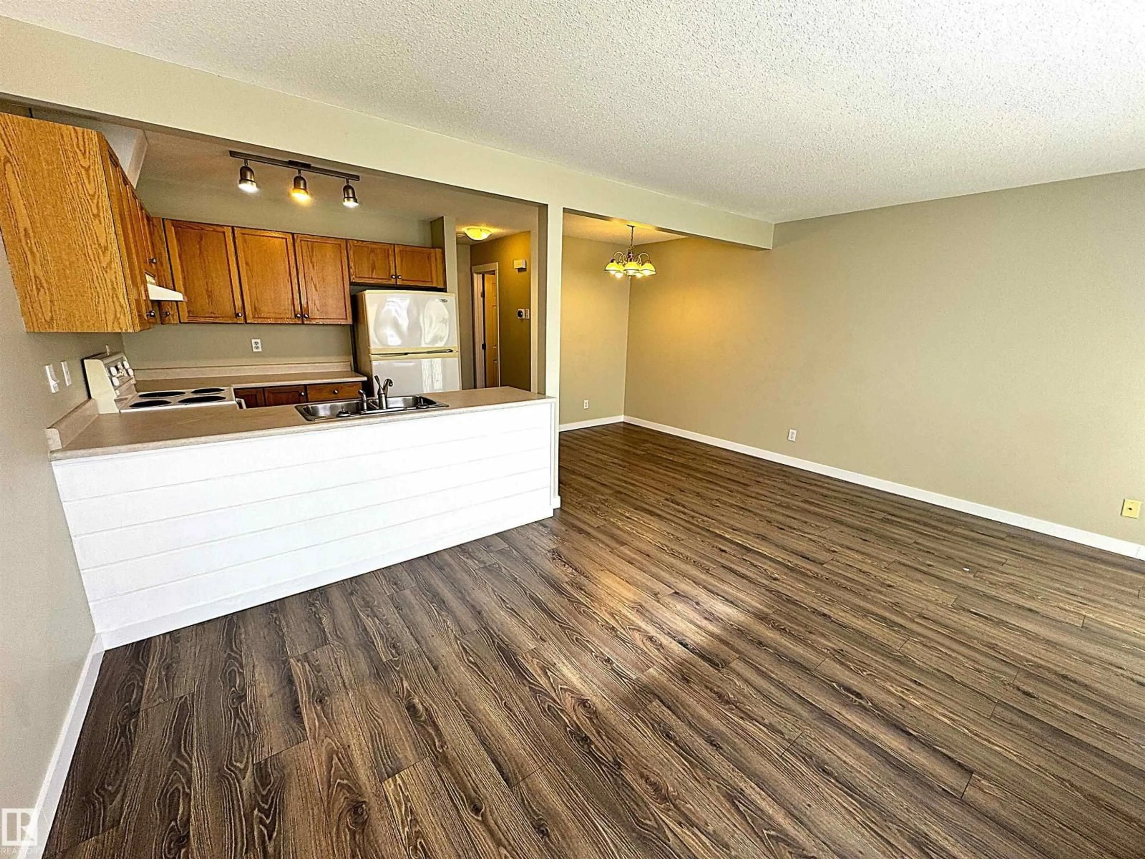 Open concept kitchen, wood/laminate floor for #17 - 16823 84 ST, Edmonton Alberta T5Z3S4
