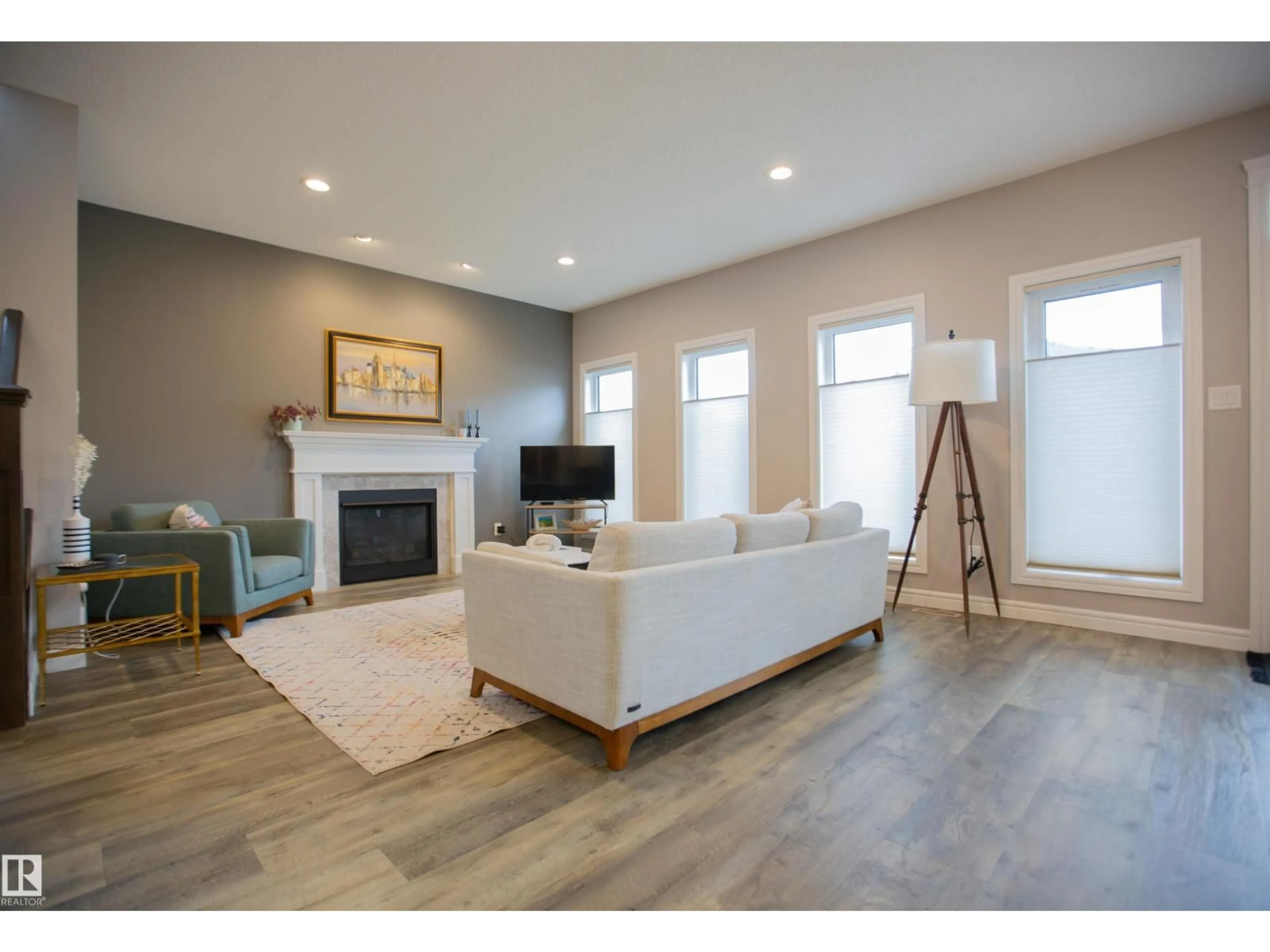 Living room with furniture, wood/laminate floor for SW - 1736 162 ST, Edmonton Alberta T6W3E8
